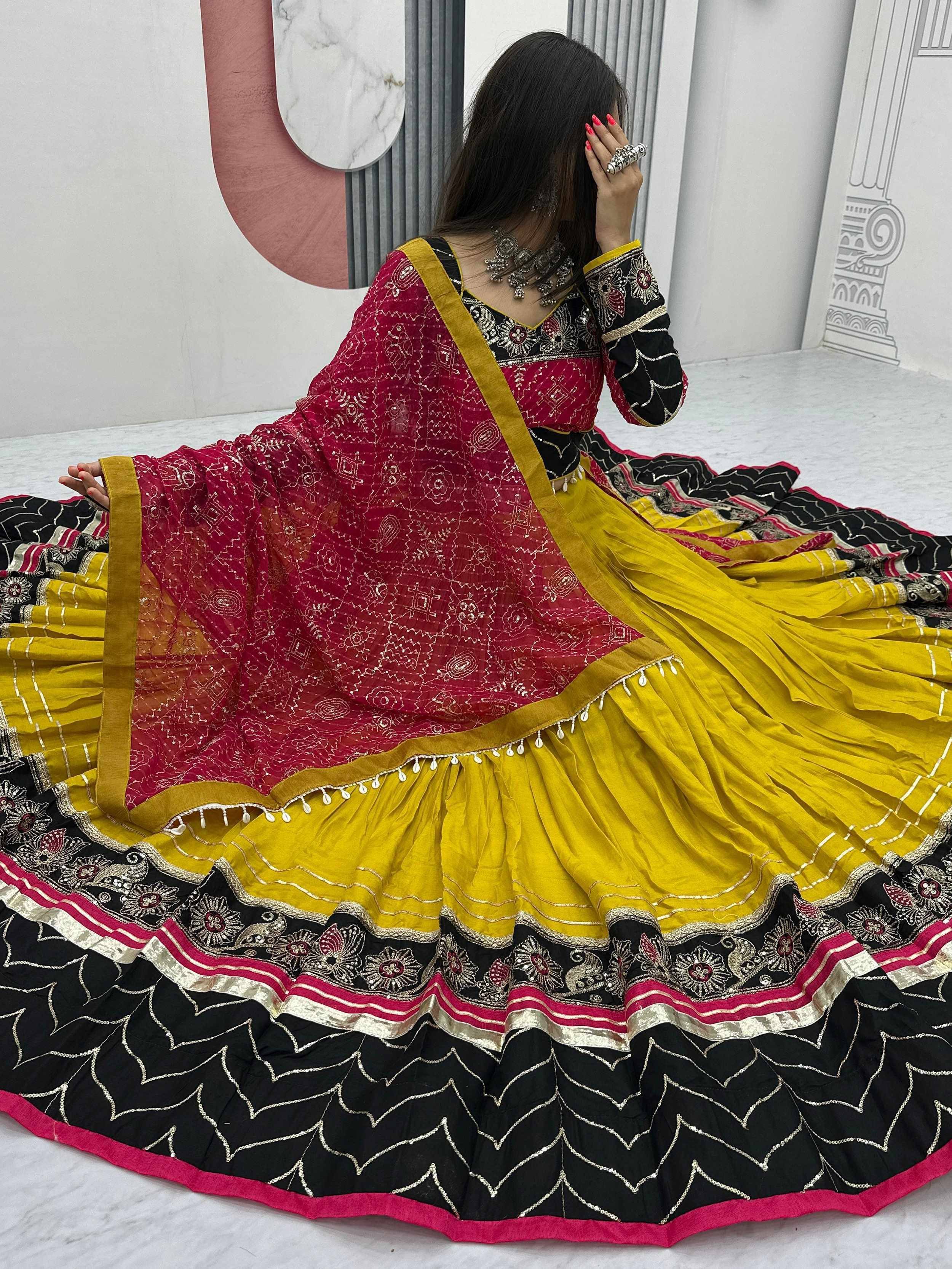 Vibrant yellow and black embroidered lehenga choli with red dupatta, perfect for Indian ethnic wear