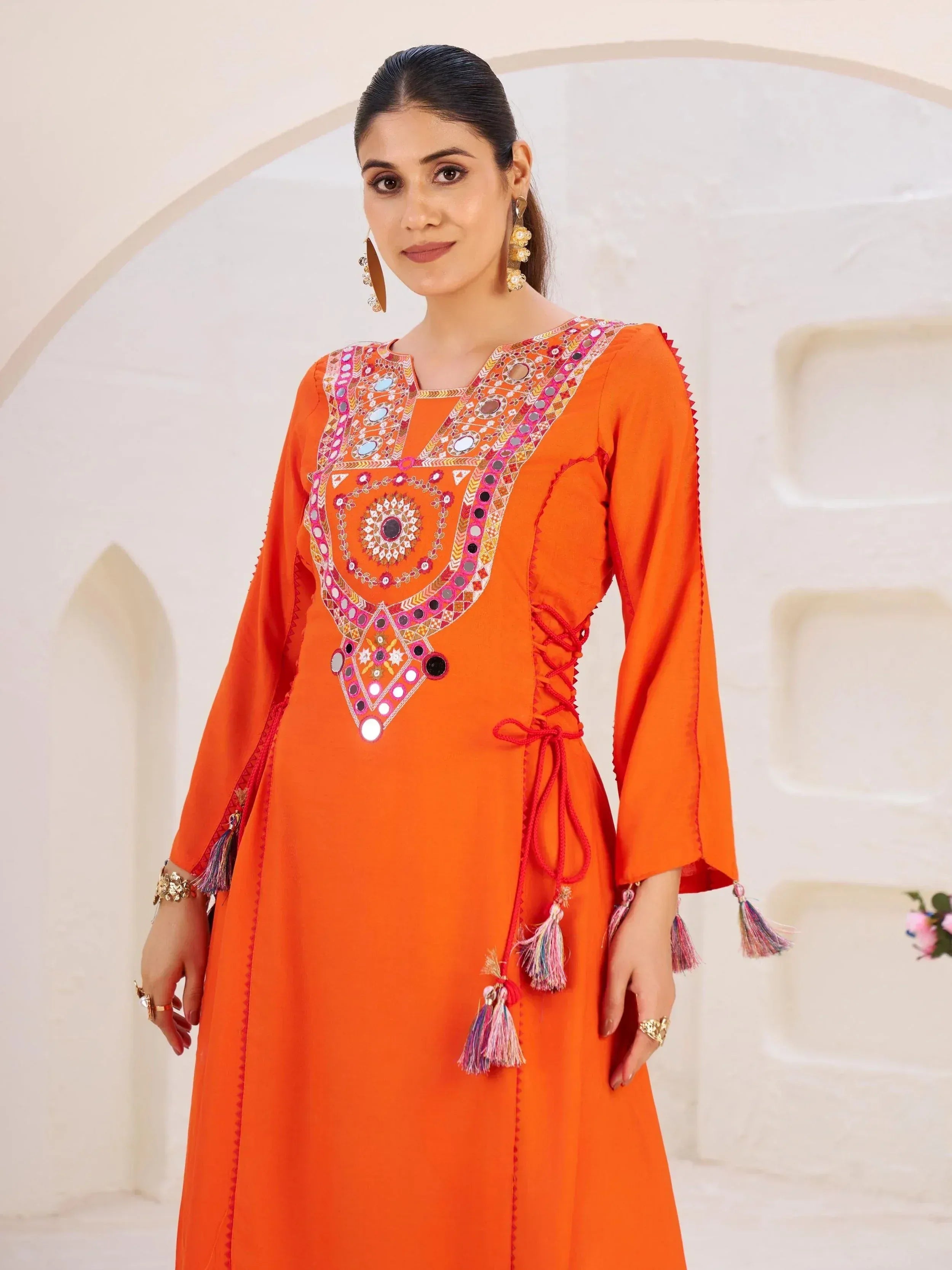 Orange ethnic kurta with mirror work, tassels, and side lace-up detail for women