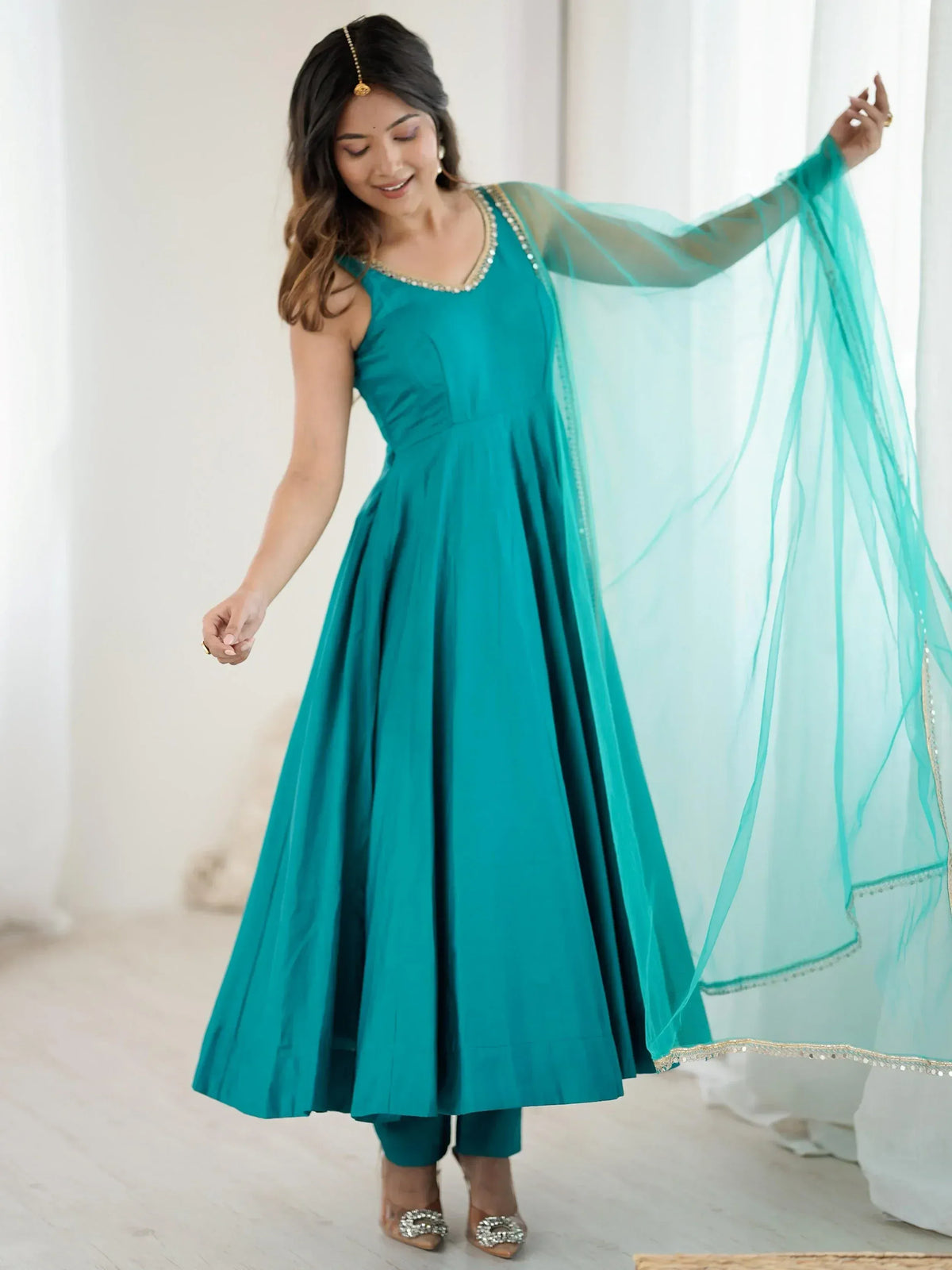 Teal ethnic gown with sheer dupatta, perfect for Indian festive occasions and weddings