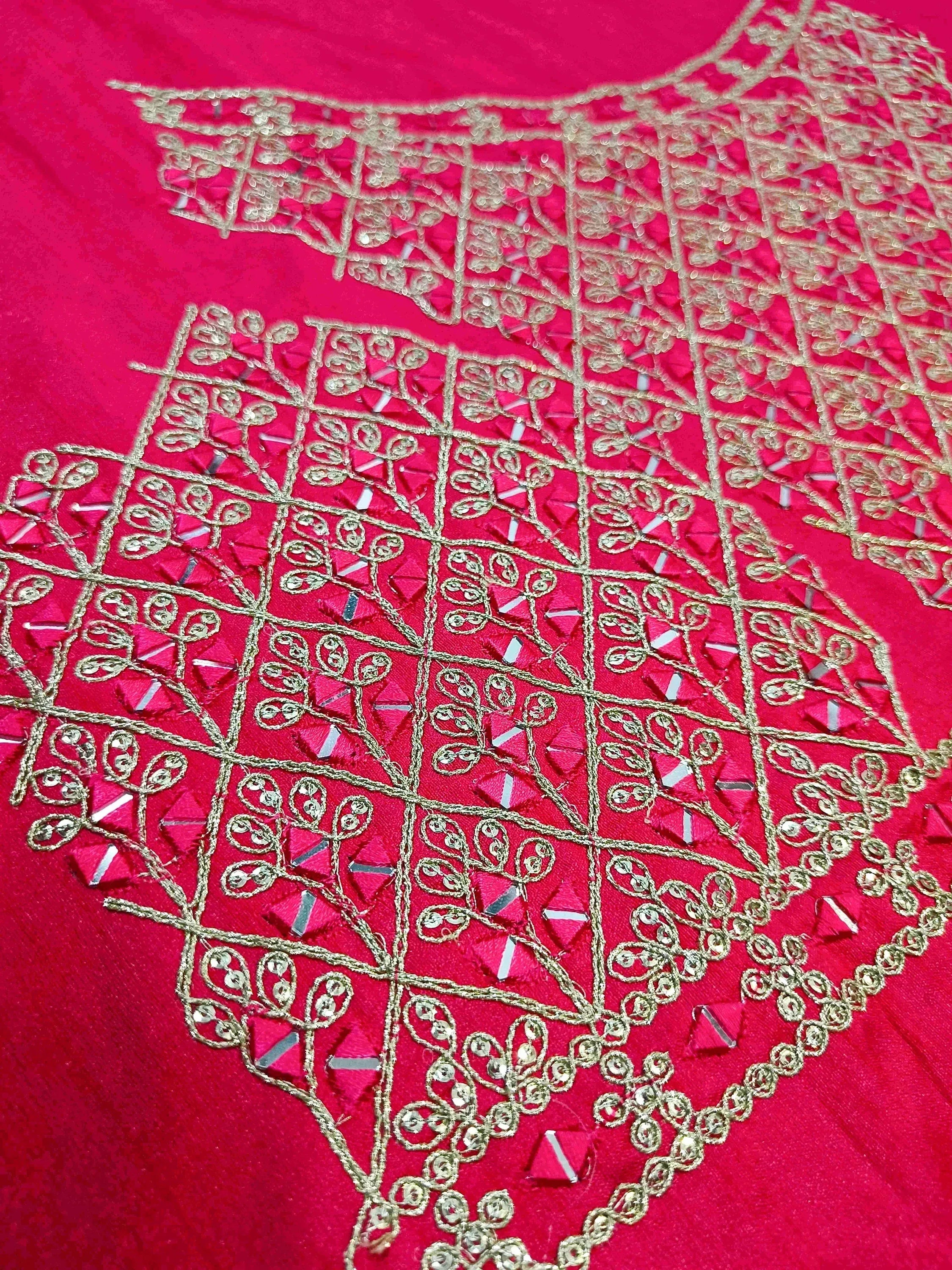 Vibrant red ethnic wear with intricate gold embroidery and mirror work, perfect for festive occasions.