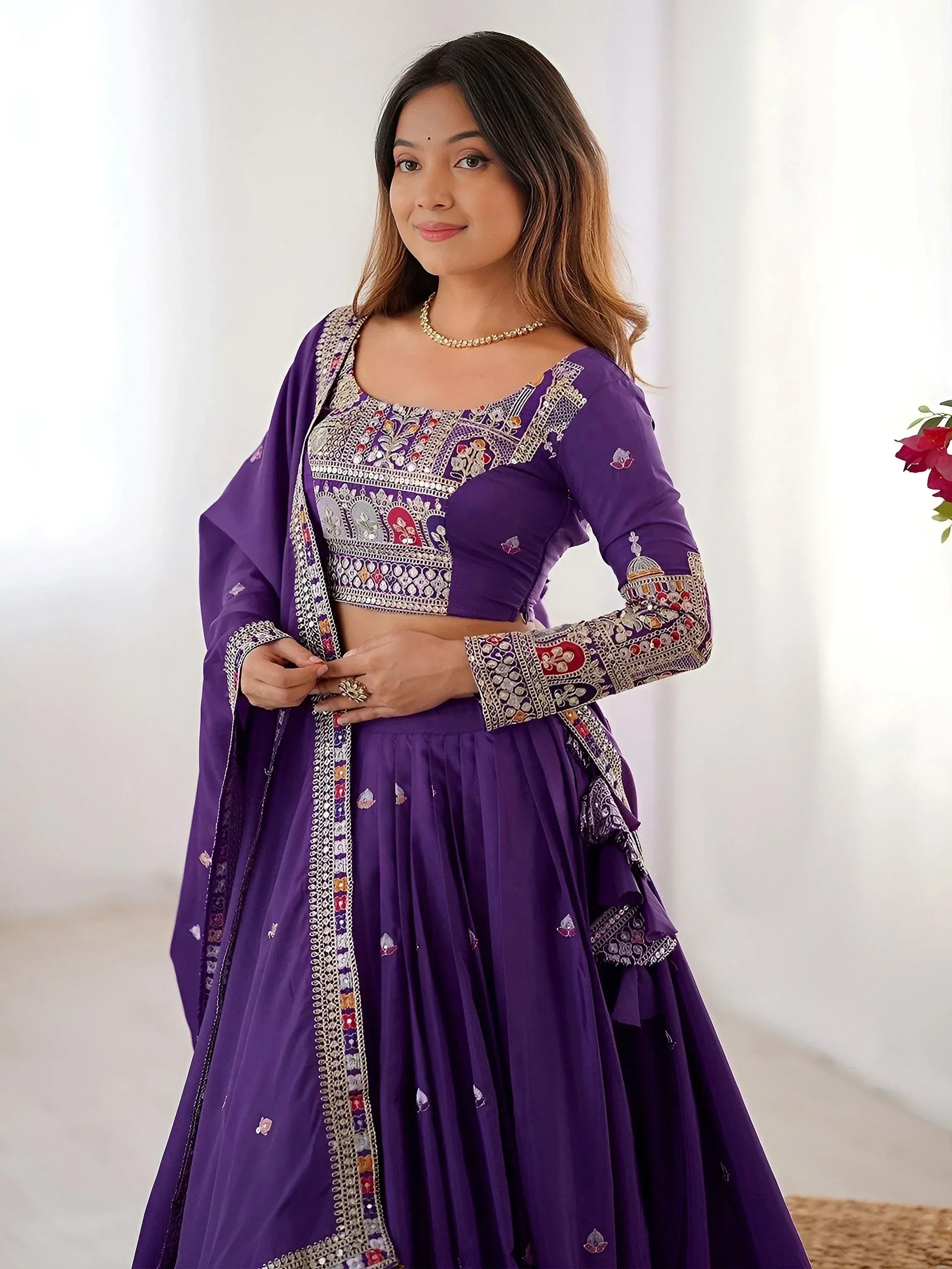 Purple embroidered lehenga choli with mirror work, perfect for Indian ethnic wear and festive occasions.