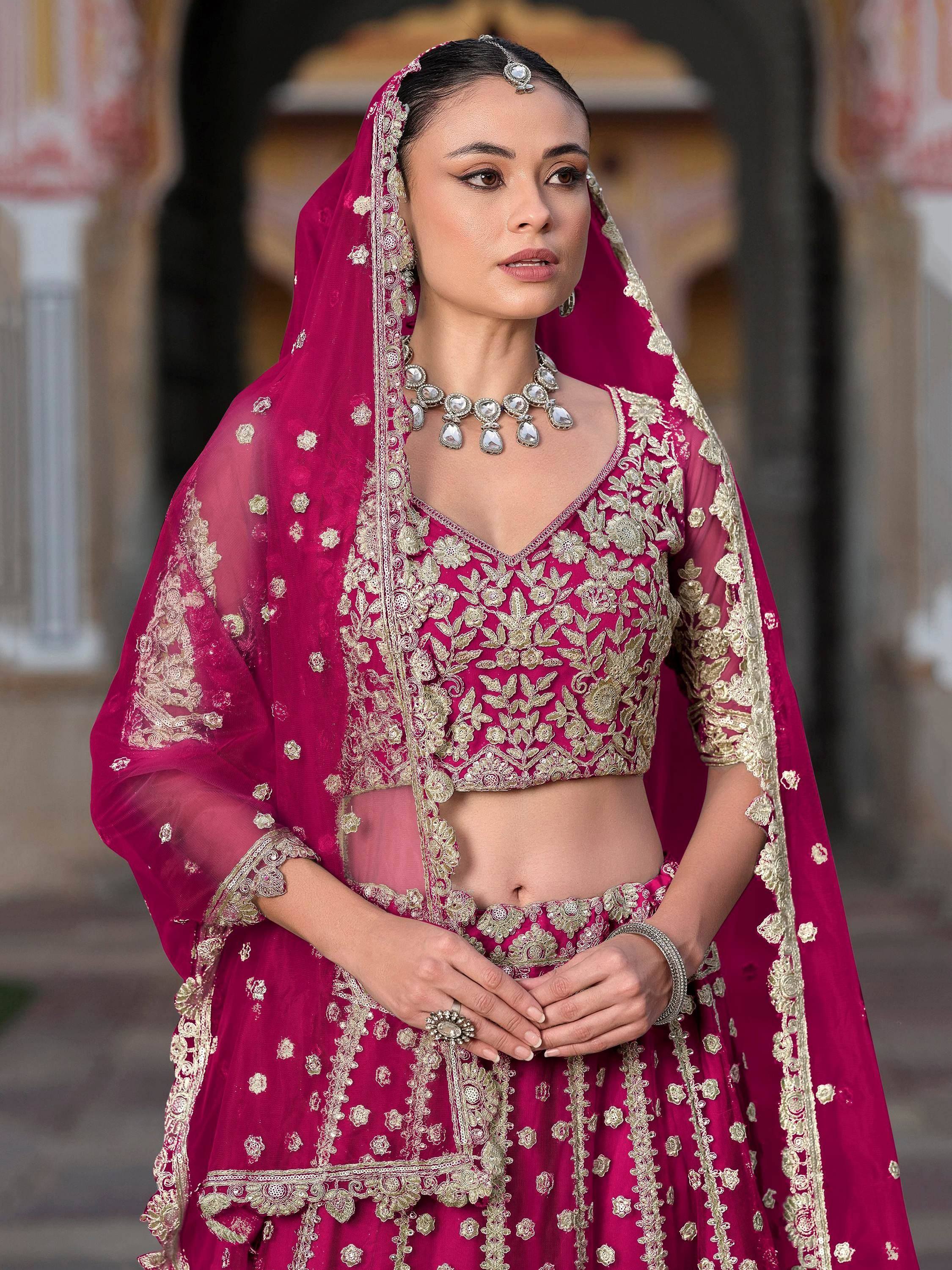Elegant maroon lehenga choli with gold embroidery, perfect for Indian weddings and festive occasions.