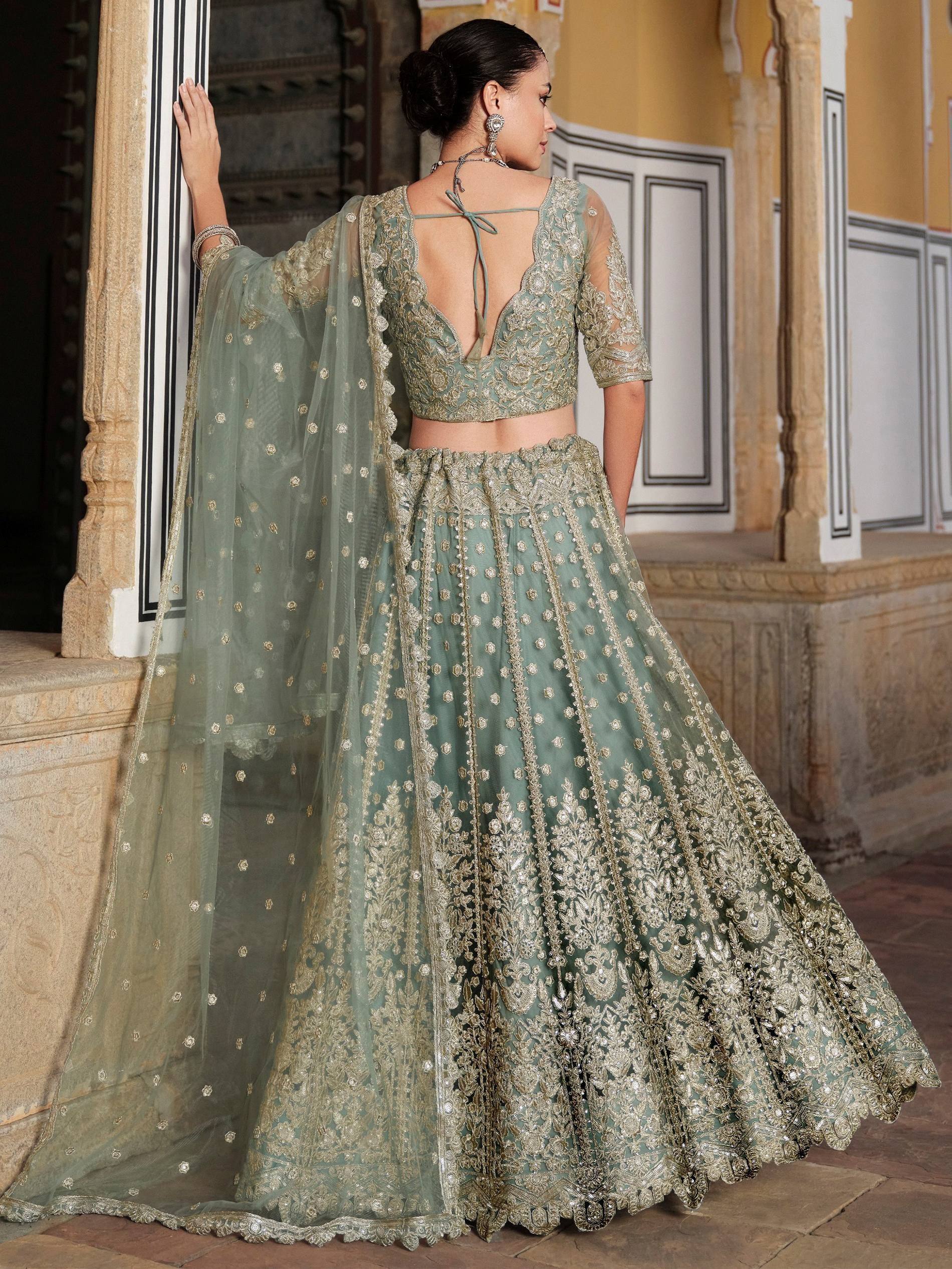 Elegant sage green lehenga choli with gold embroidery, perfect for Indian weddings and festive occasions.