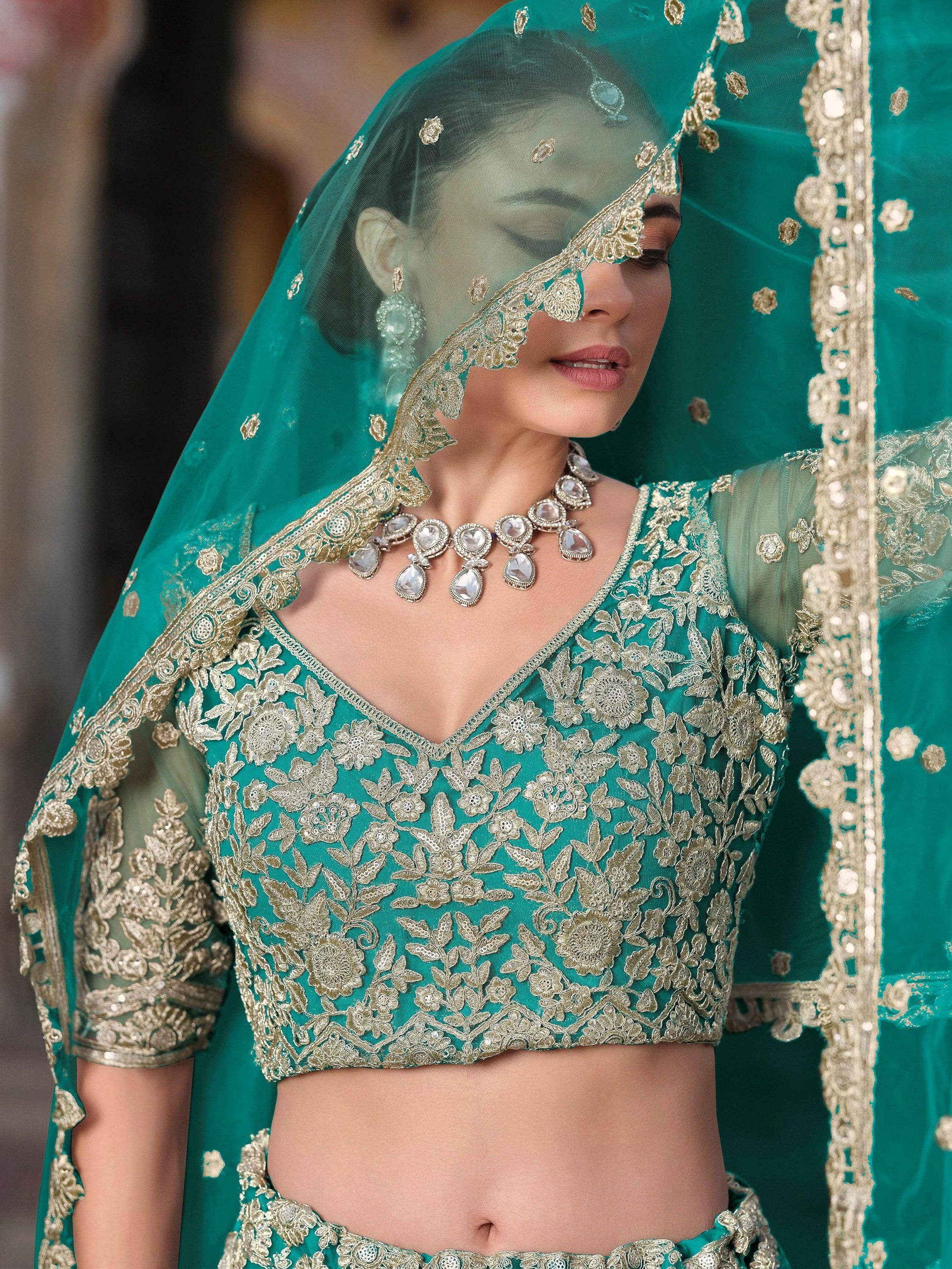 Teal green embroidered lehenga choli with gold floral work and matching dupatta for Indian weddings