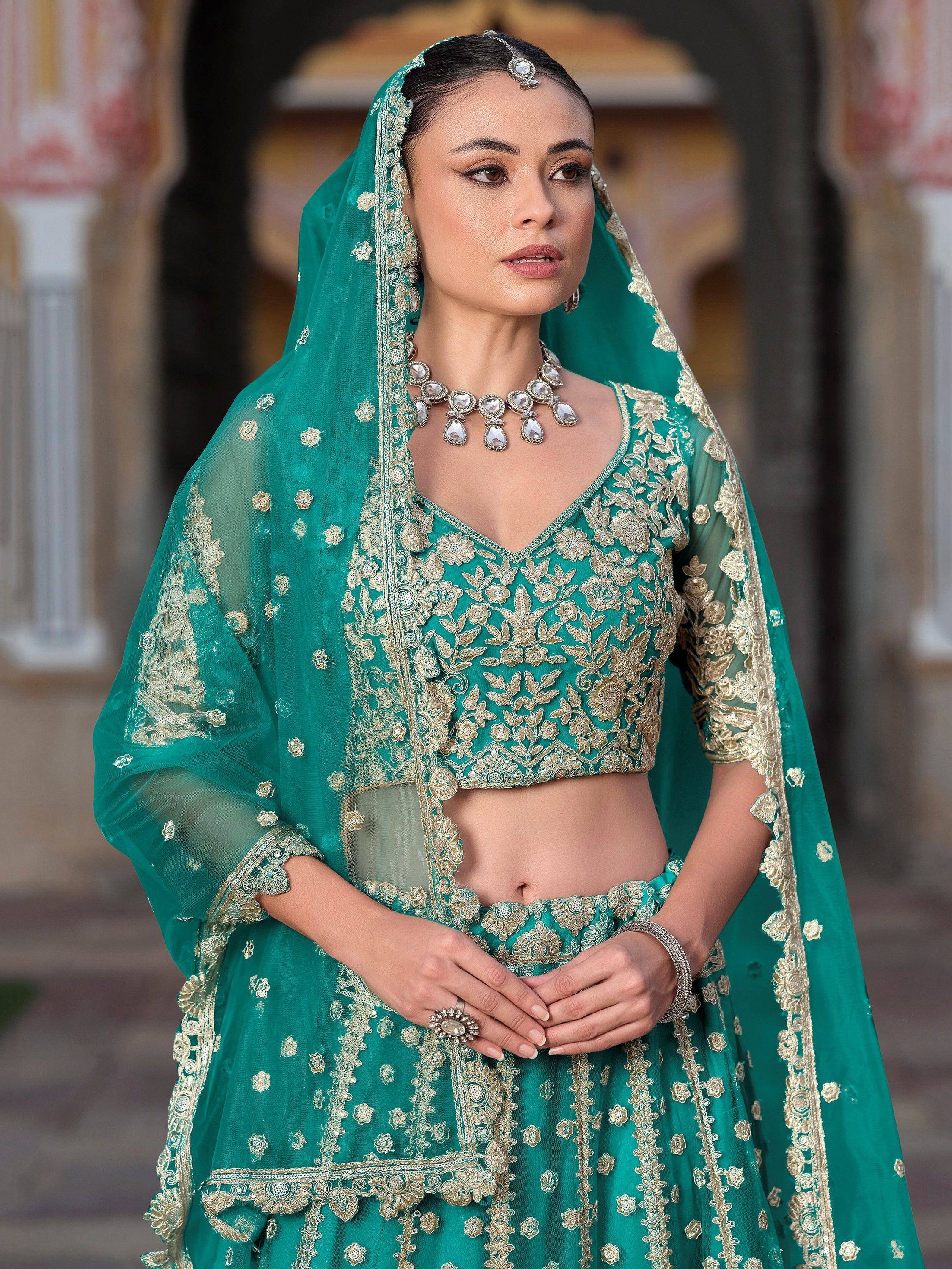 Emerald green designer lehenga choli with gold embroidery, perfect for Indian weddings and festive occasions.