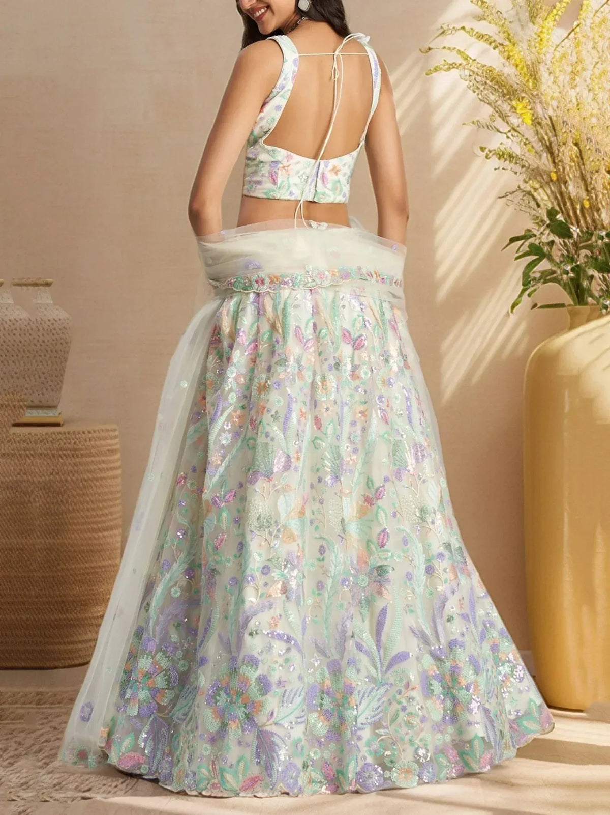 Elegant floral embroidered lehenga choli with pastel hues and open back design