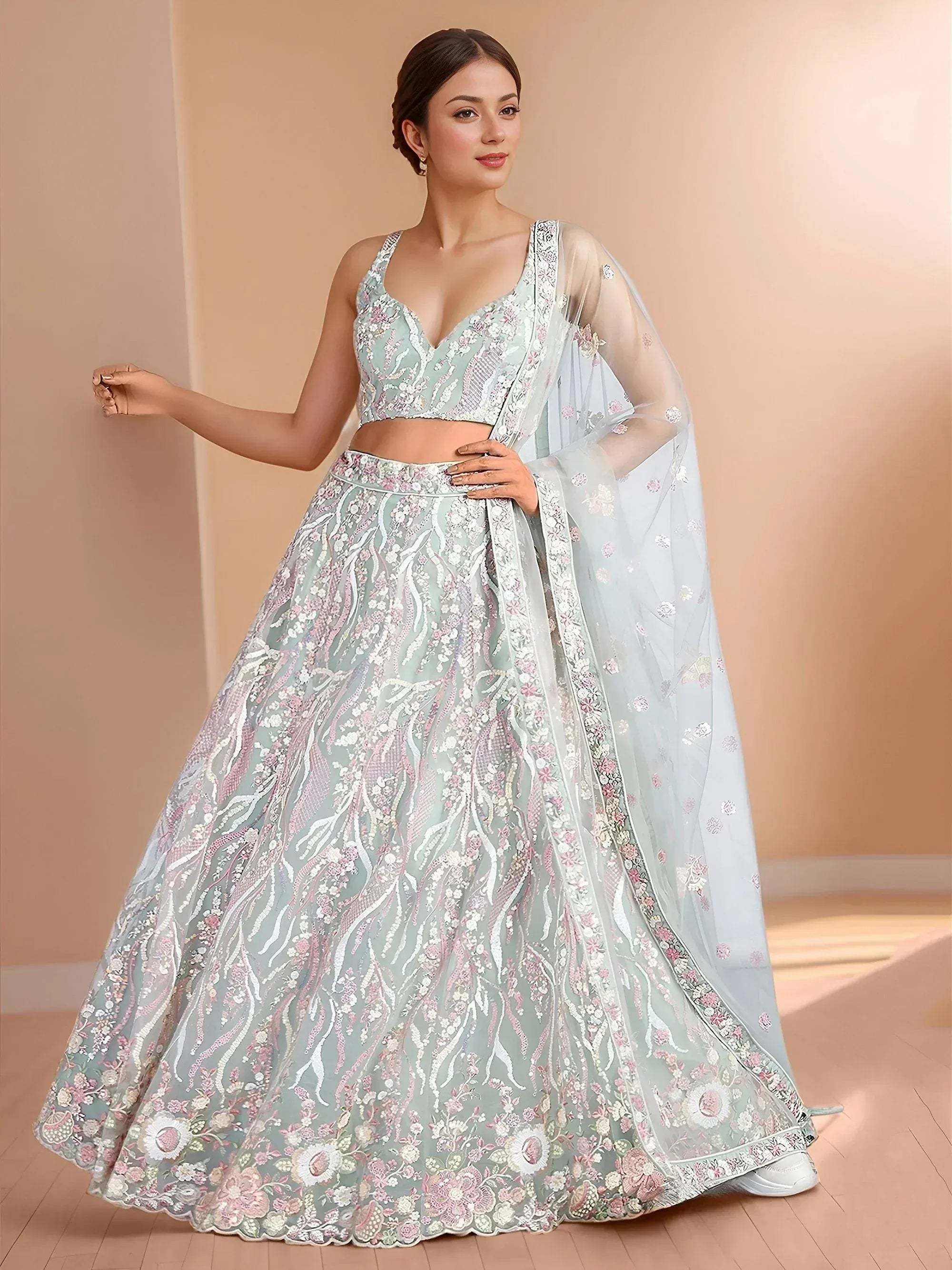 Elegant mint green lehenga choli with floral embroidery and sheer dupatta for Indian ethnic wear