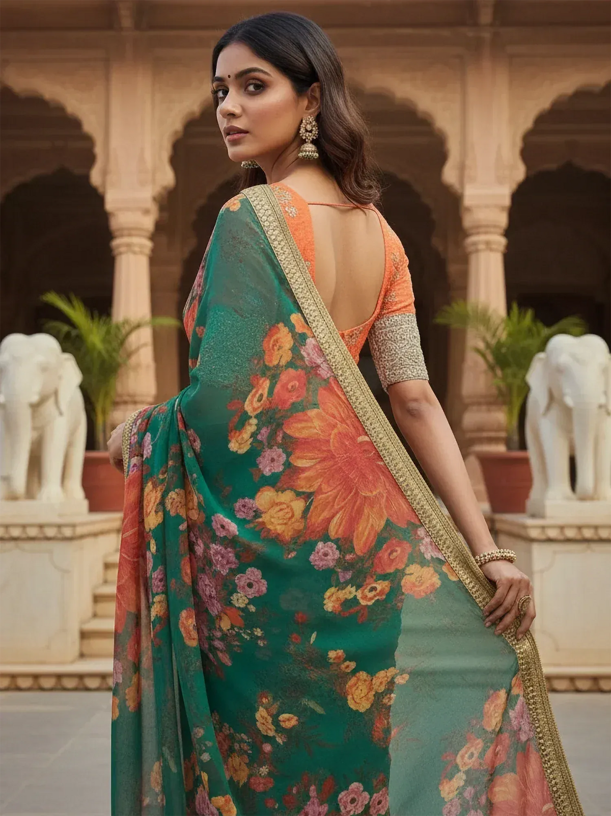 Woman in green floral saree with orange blouse, traditional Indian ethnic wear, palace backdrop