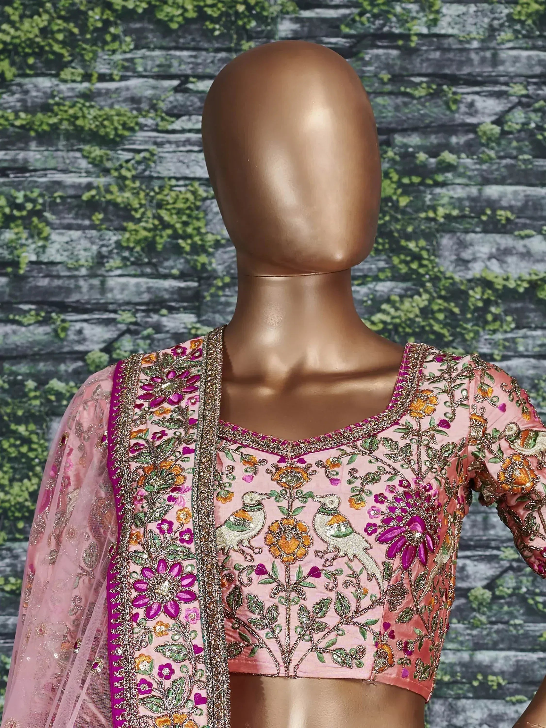 Pink embroidered lehenga choli with floral and bird motifs, perfect for Indian ethnic wear
