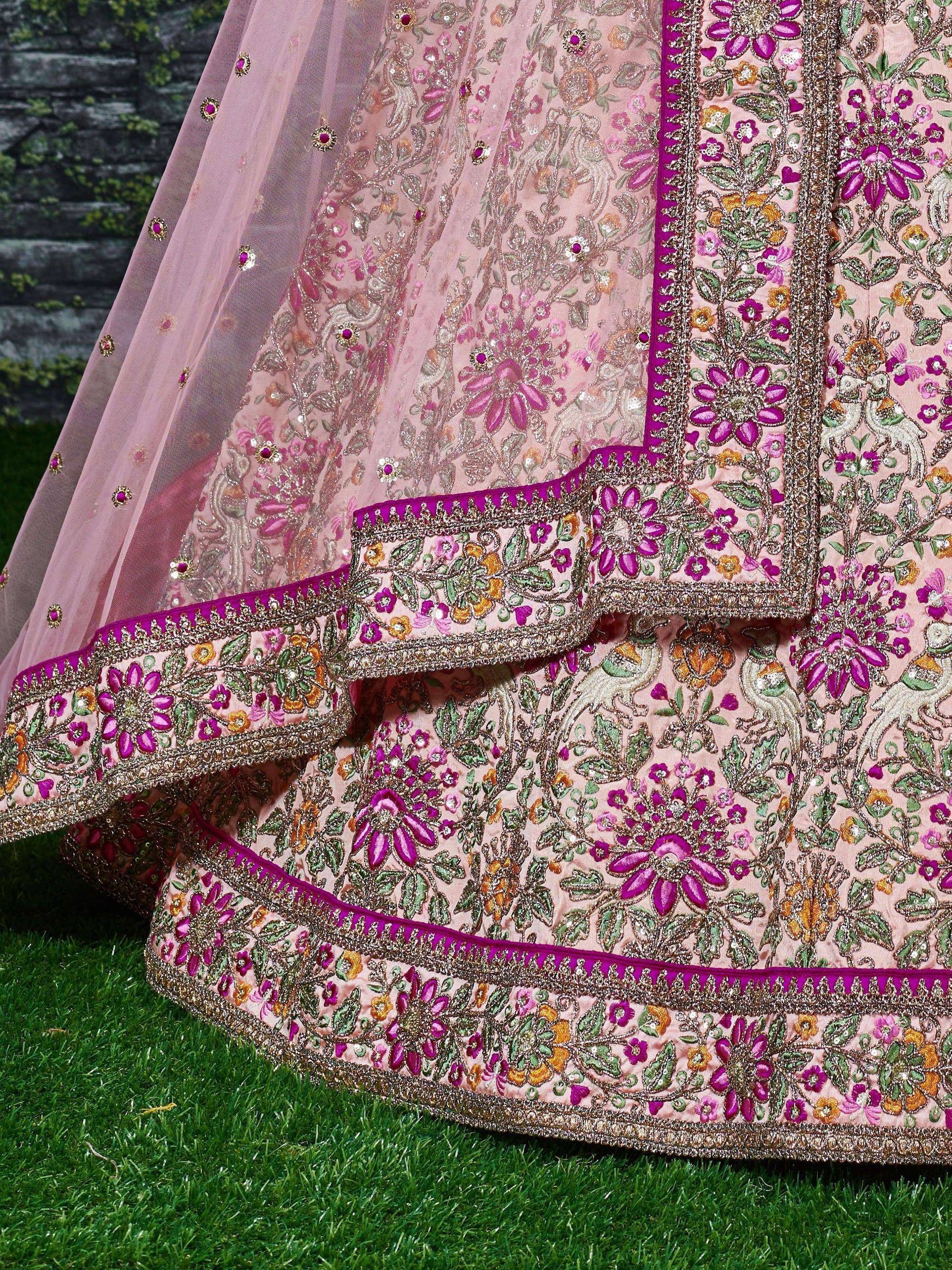 Pink floral embroidered lehenga choli with magenta border, perfect for Indian weddings and festive occasions.
