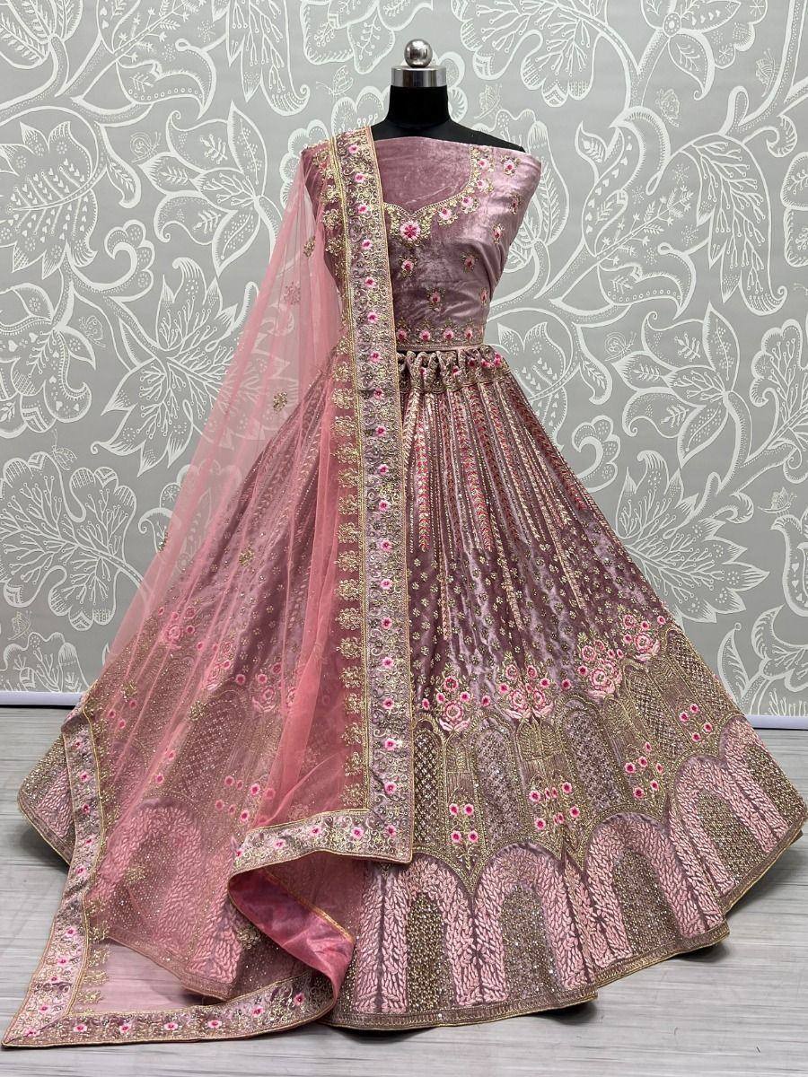 Pink velvet lehenga choli with gold embroidery and floral motifs, perfect for Indian weddings and festive occasions