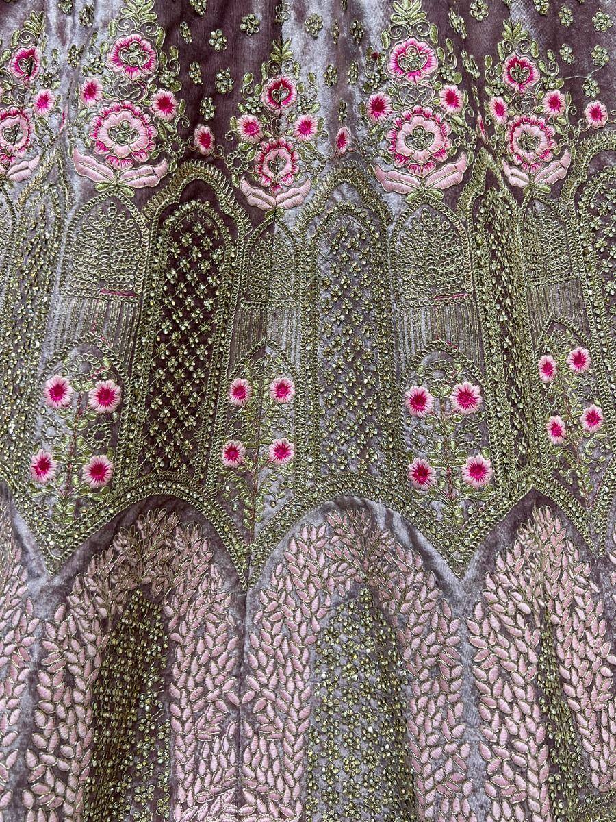 Elegant Indian ethnic wear with intricate floral embroidery in pink and gold on velvet fabric