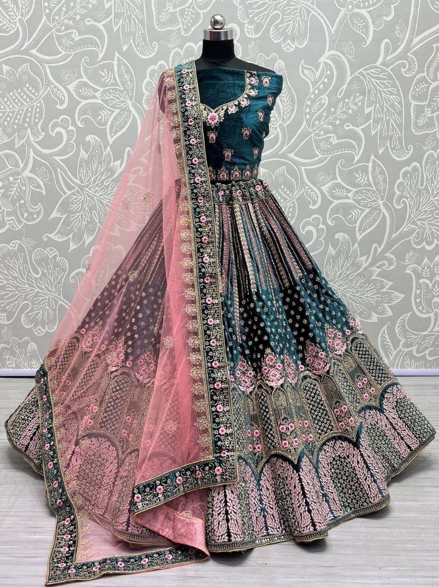 Teal and pink embroidered lehenga choli with floral motifs and sheer dupatta, perfect for Indian ethnic occasions.