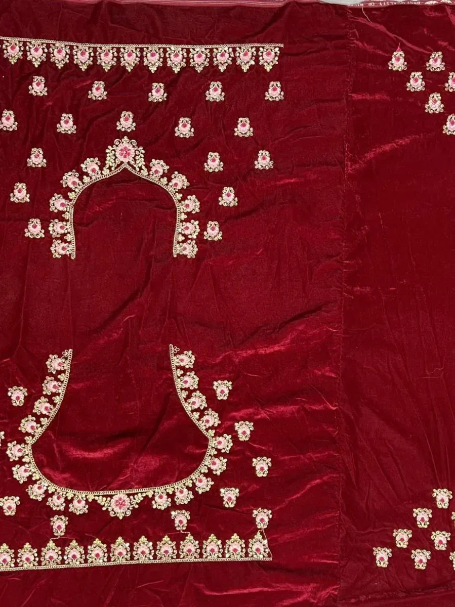 Rich maroon velvet lehenga choli with intricate floral embroidery and embellished neckline details