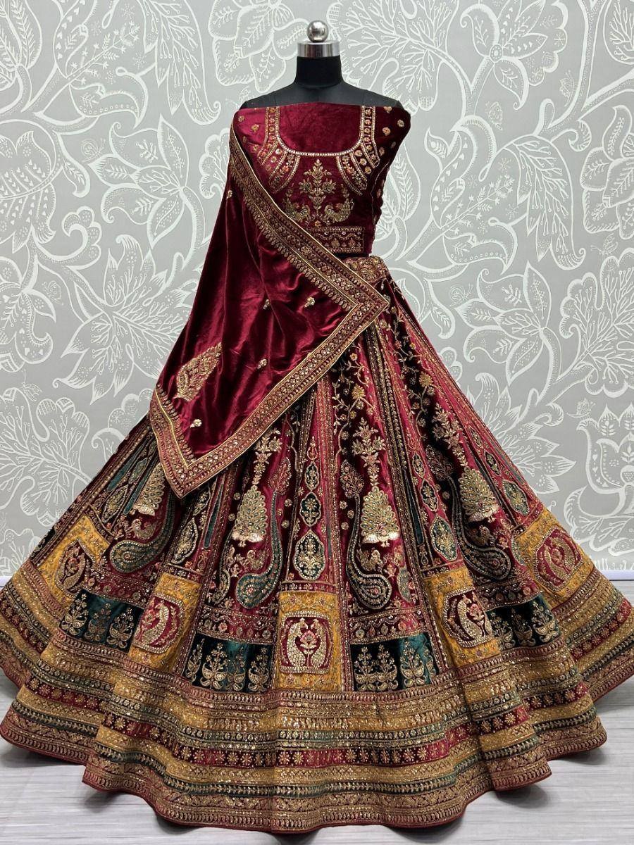 Maroon velvet designer lehenga choli with gold embroidery, perfect for Indian weddings and festive occasions