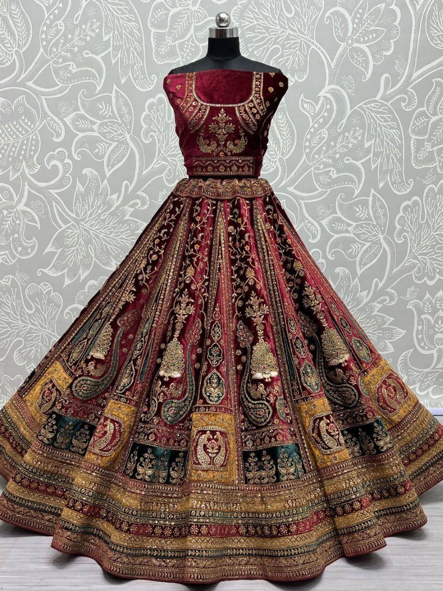 Maroon velvet designer lehenga choli with gold embroidery, perfect for Indian weddings and festive occasions