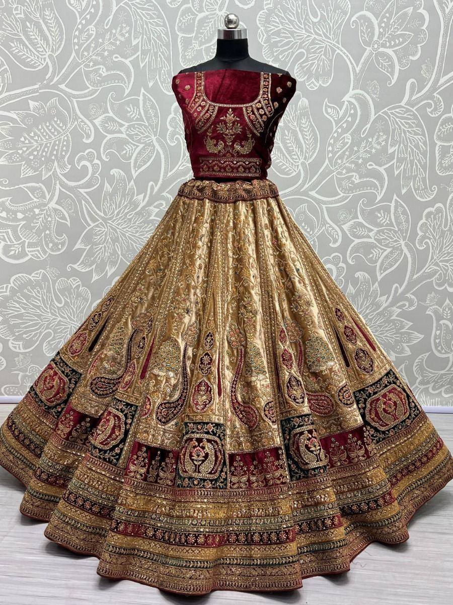 Maroon and gold embroidered lehenga choli with intricate paisley patterns, perfect for Indian ethnic wear occasions.