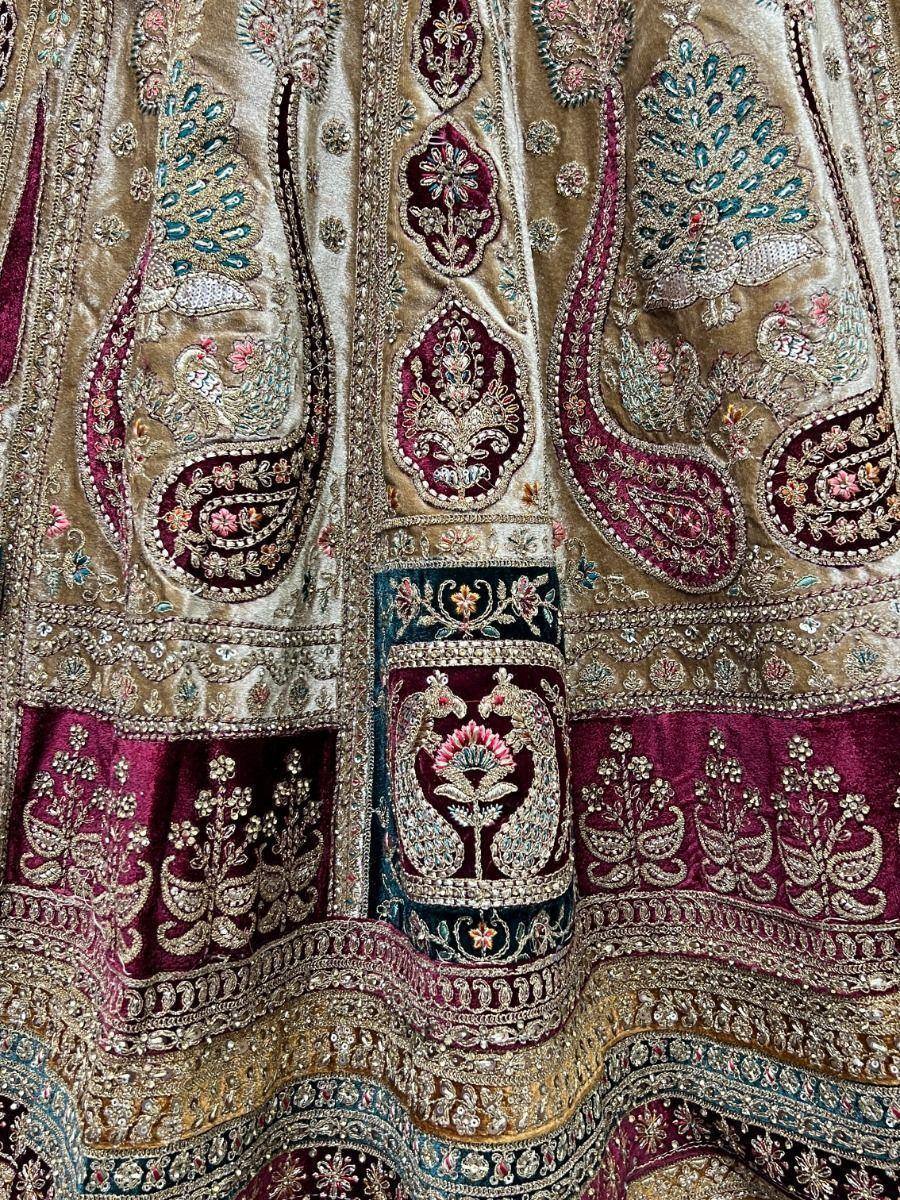 Luxury Indian lehenga with peacock embroidery, velvet fabric, and intricate gold zari work for weddings