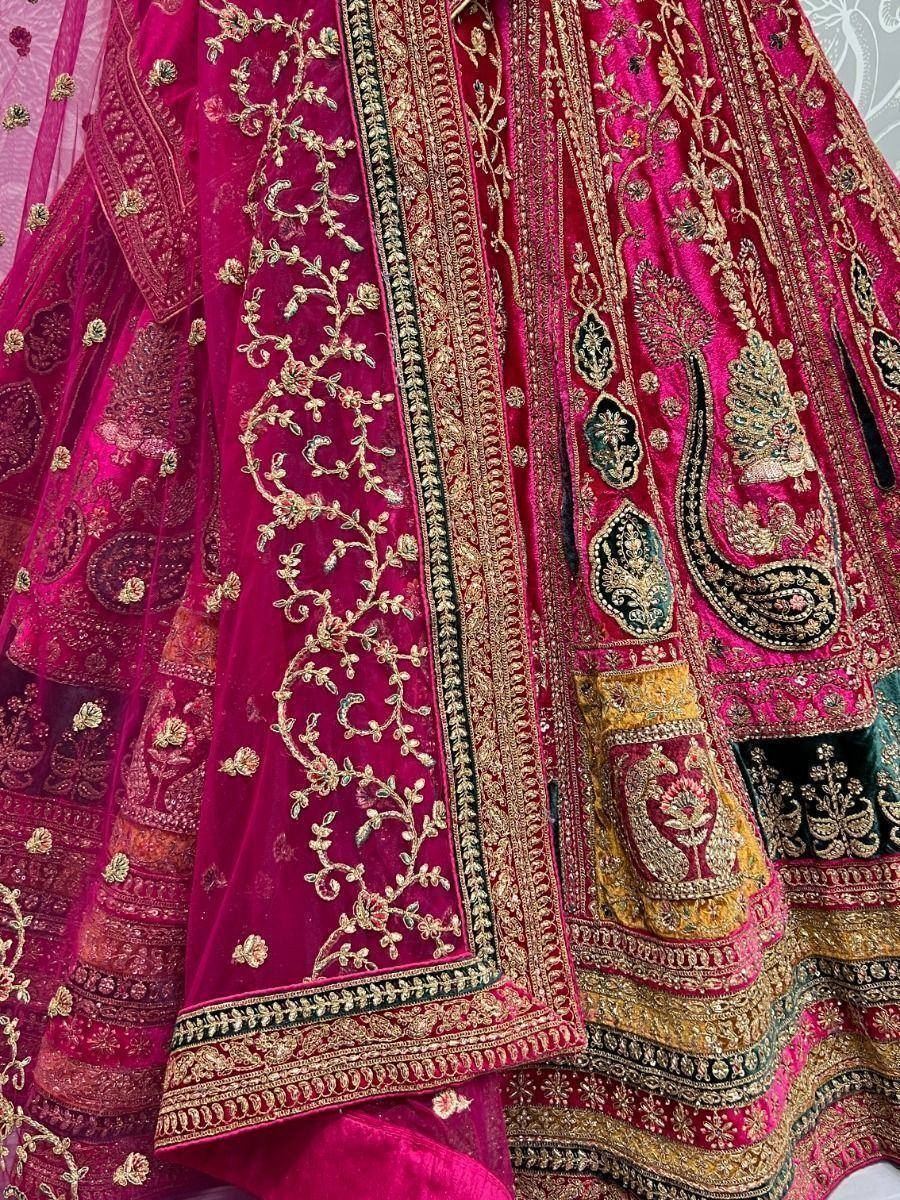 Luxury pink velvet lehenga choli with gold embroidery and intricate paisley designs for Indian weddings