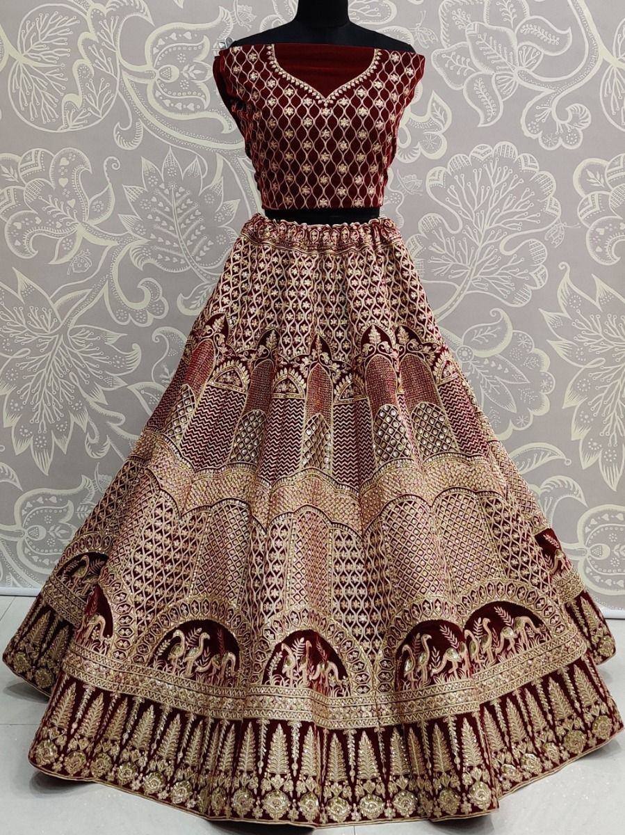 Maroon and gold embroidered lehenga choli with intricate patterns and peacock motifs, perfect for Indian ethnic wear.