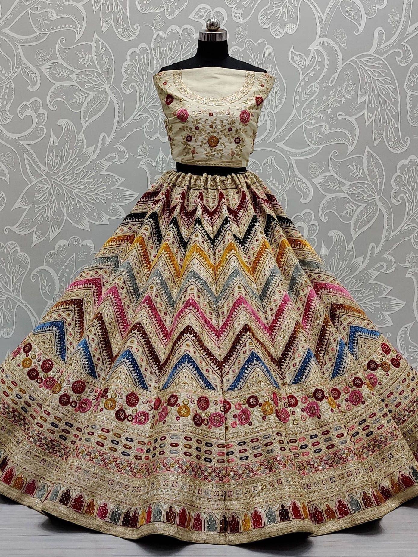 Designer lehenga choli with colorful geometric embroidery, perfect for Indian ethnic wear occasions.