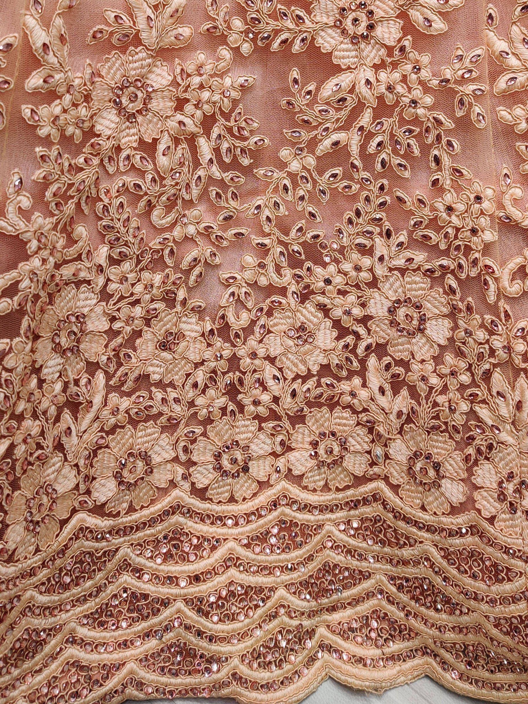 Luxury peach ethnic wear fabric with floral embroidery and sequin detailing for lehenga or saree