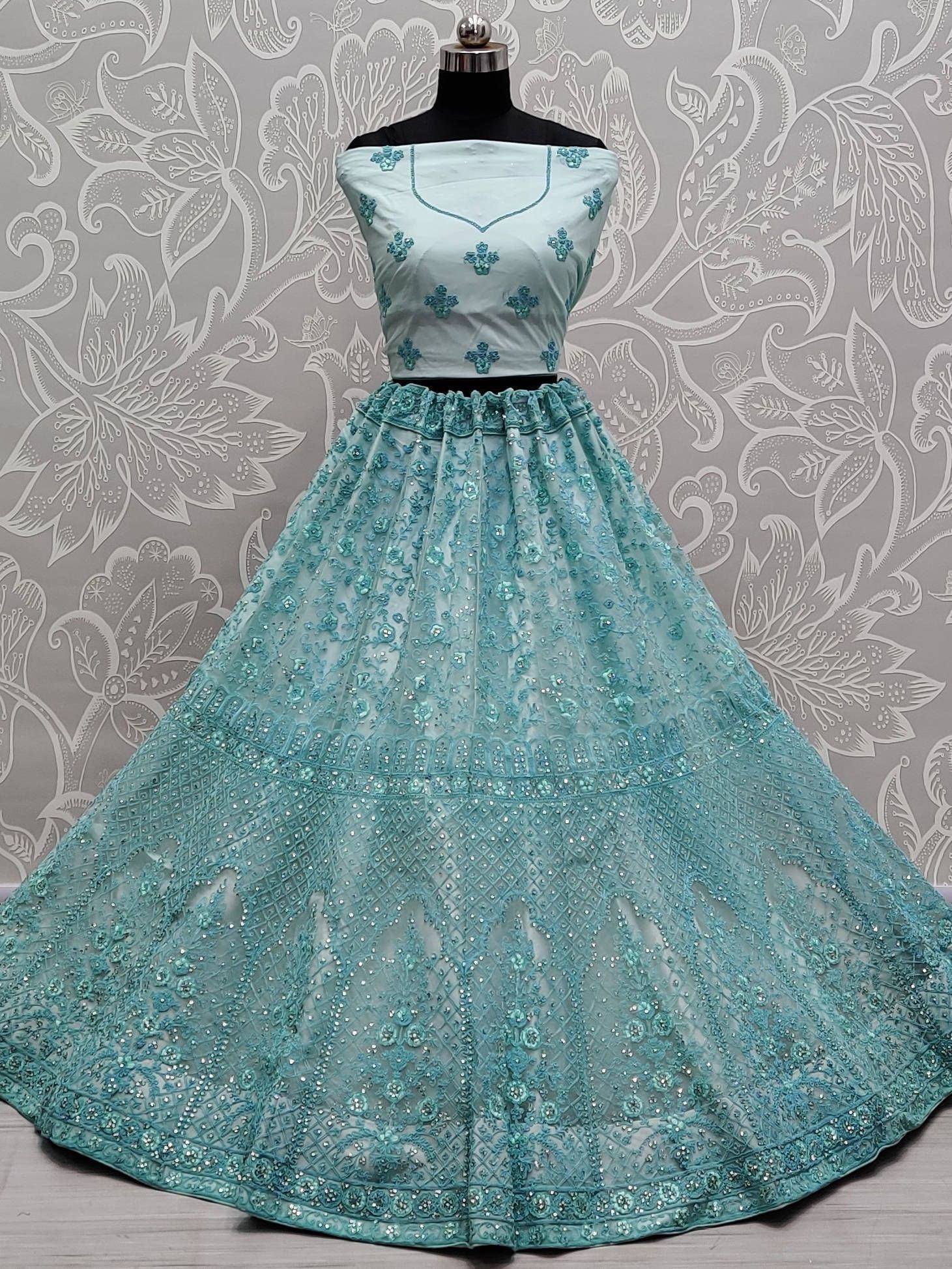 Mint green designer lehenga choli with floral embroidery and sequin work, perfect for Indian ethnic occasions.
