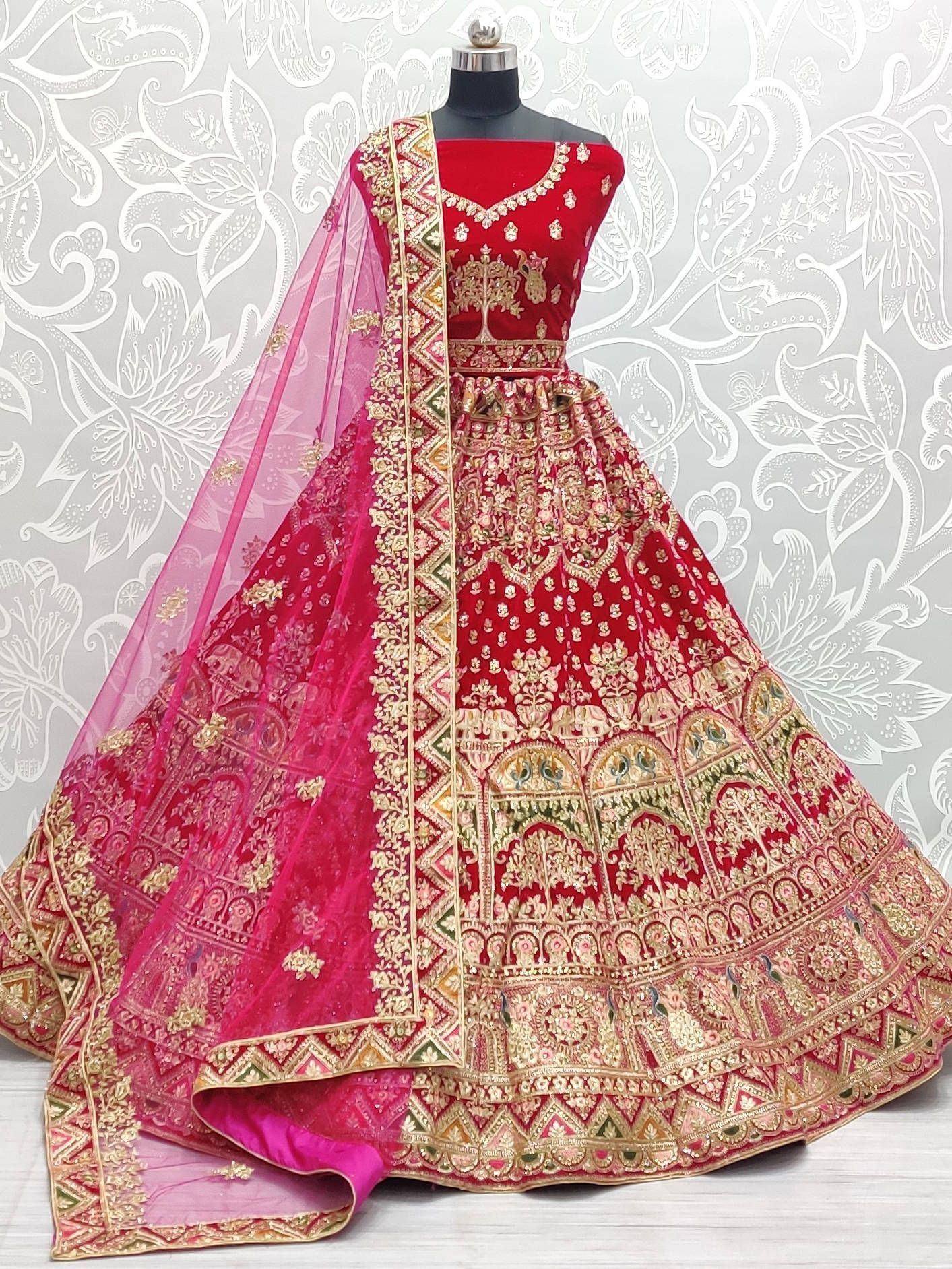 Red and pink embroidered lehenga choli with gold detailing, perfect for Indian weddings and festive occasions.