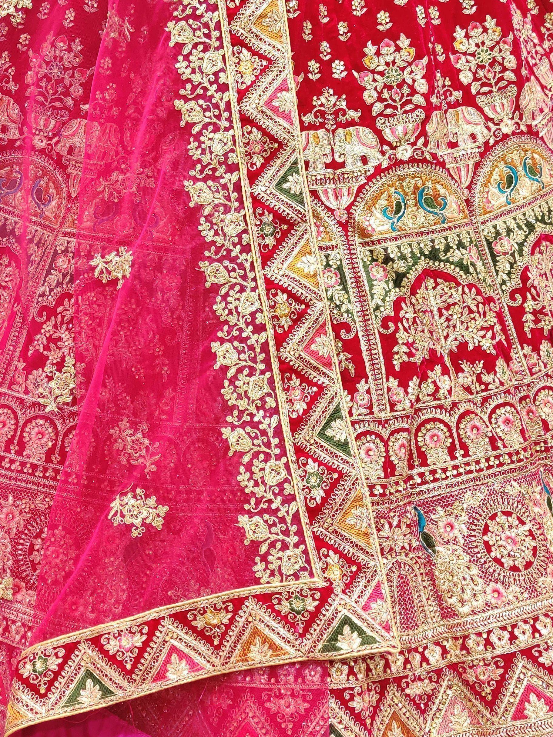 Red velvet lehenga with gold embroidery, peacock & elephant motifs, sheer pink dupatta