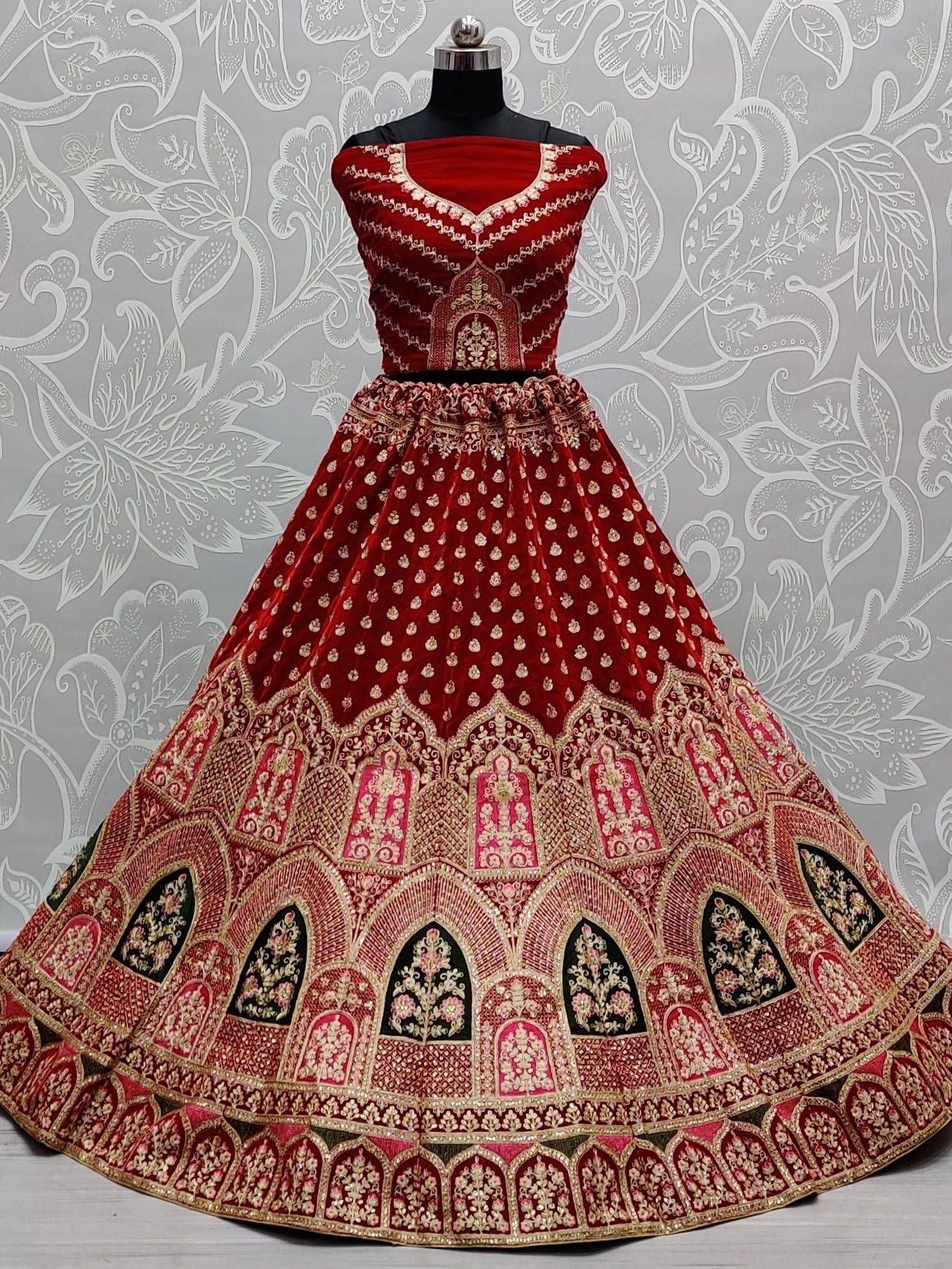 Red velvet designer lehenga choli with gold embroidery, perfect for Indian weddings and festive occasions