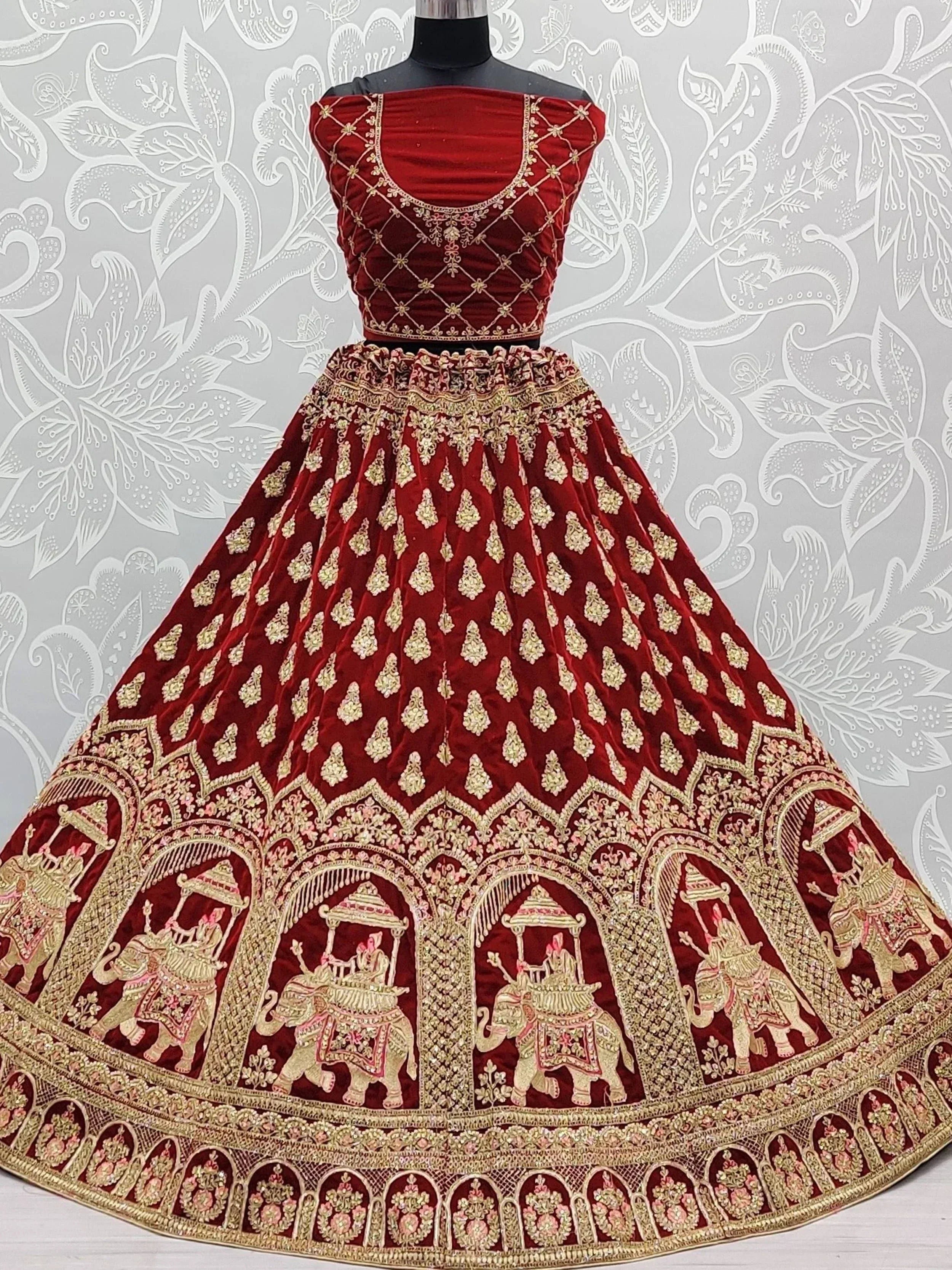 Red velvet lehenga choli with gold elephant embroidery, designer Indian ethnic wear for weddings