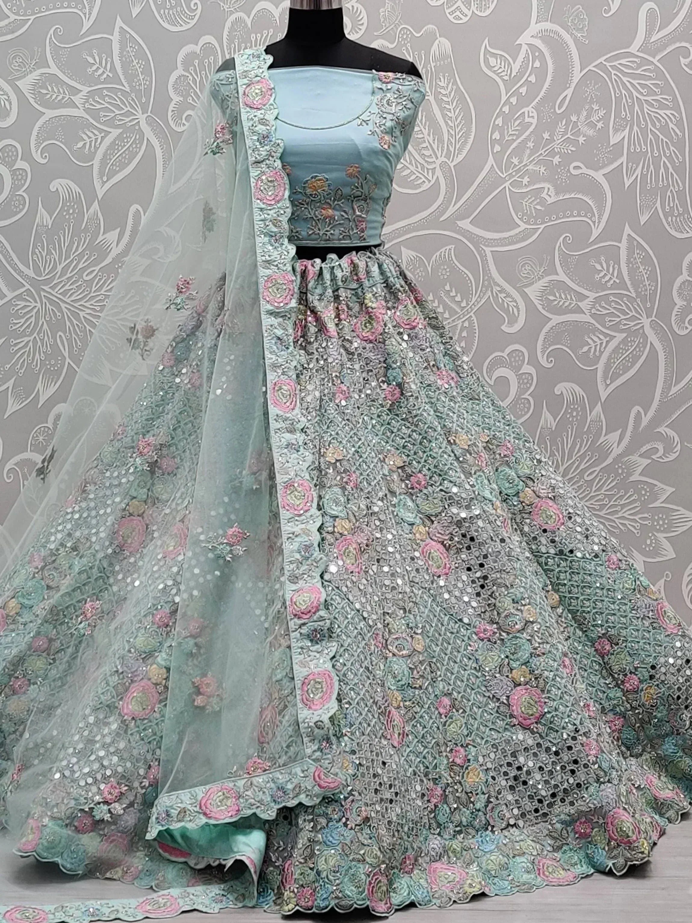 Mint green designer lehenga choli with floral embroidery and sequins, perfect for Indian weddings and festive occasions.