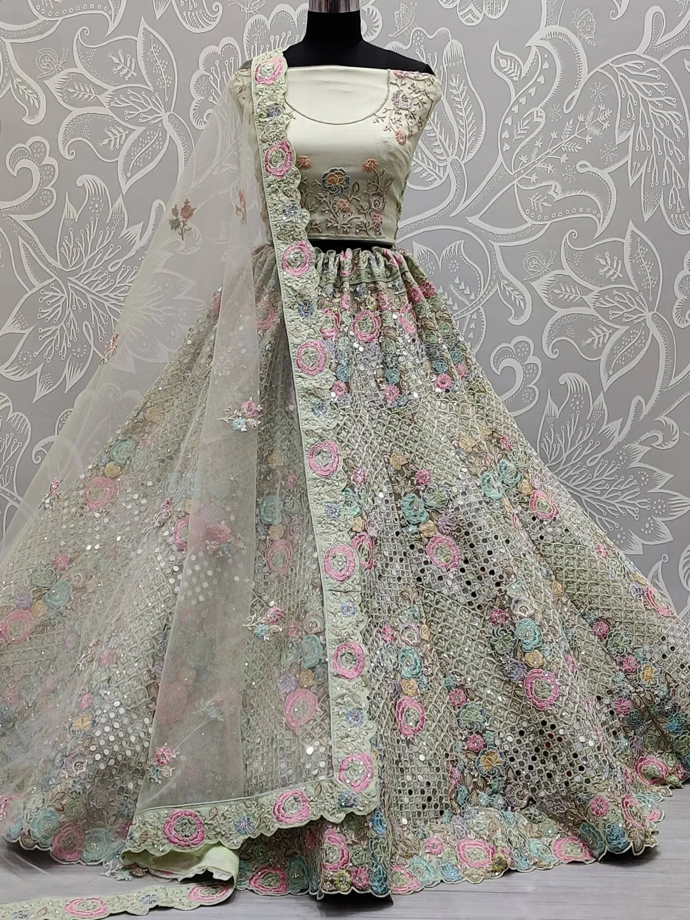 Pastel green lehenga choli with floral embroidery and sequins, perfect for Indian weddings and festivals.