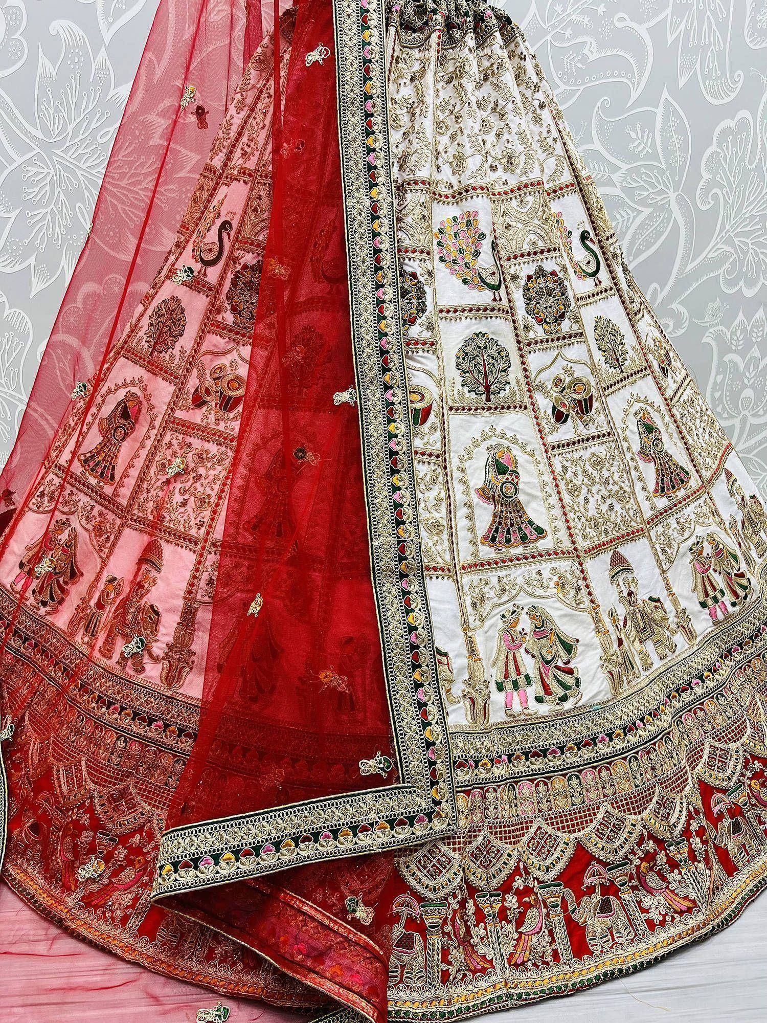 White and red embroidered lehenga with peacock and folk art motifs, perfect for Indian ethnic wear