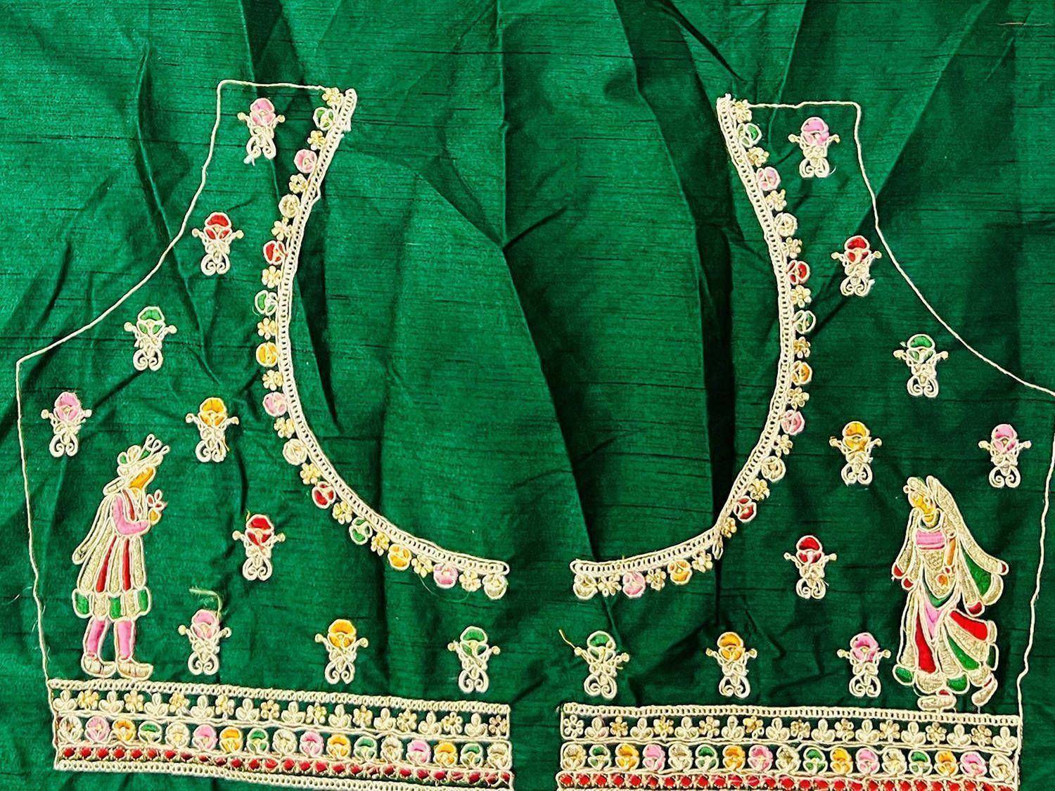 Green ethnic blouse with intricate embroidery and colorful mirror work, perfect for Indian wear.
