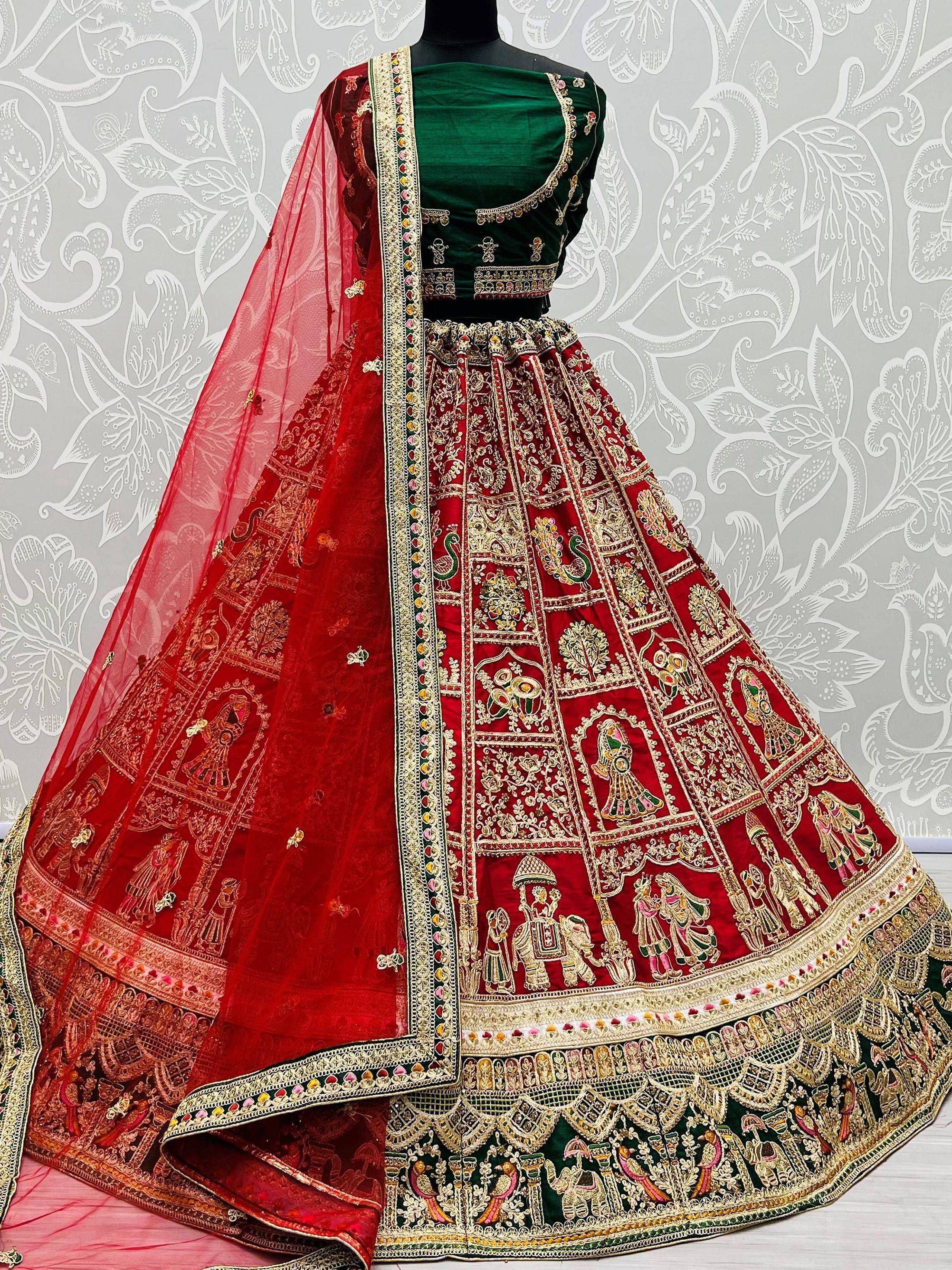 Red and green embroidered lehenga choli with intricate gold detailing and sheer dupatta, perfect for Indian weddings.