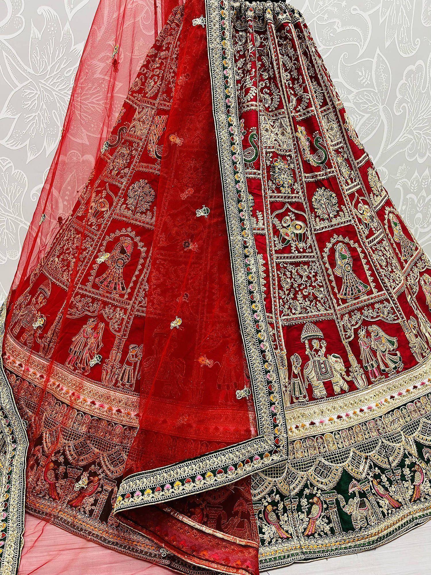 Red embroidered lehenga choli with intricate mirror work and peacock motifs, ideal for Indian weddings and festivals.