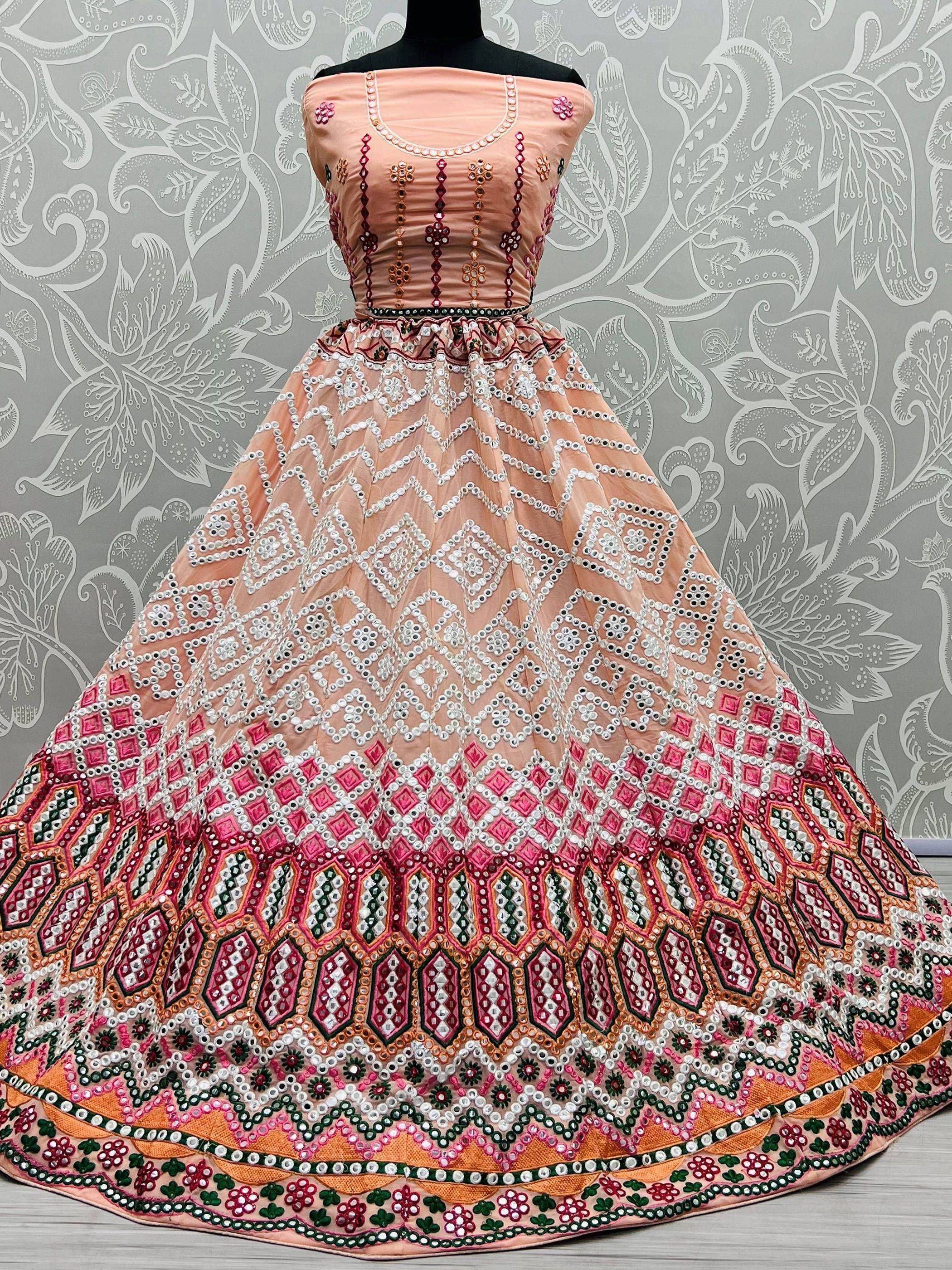 Peach designer lehenga choli with mirror work and geometric embroidery, perfect for Indian ethnic wear