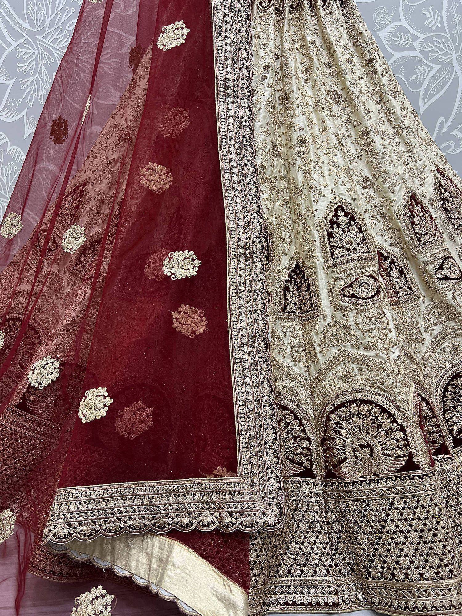 Designer lehenga choli with intricate gold embroidery, maroon dupatta, and peacock motifs for Indian ethnic wear