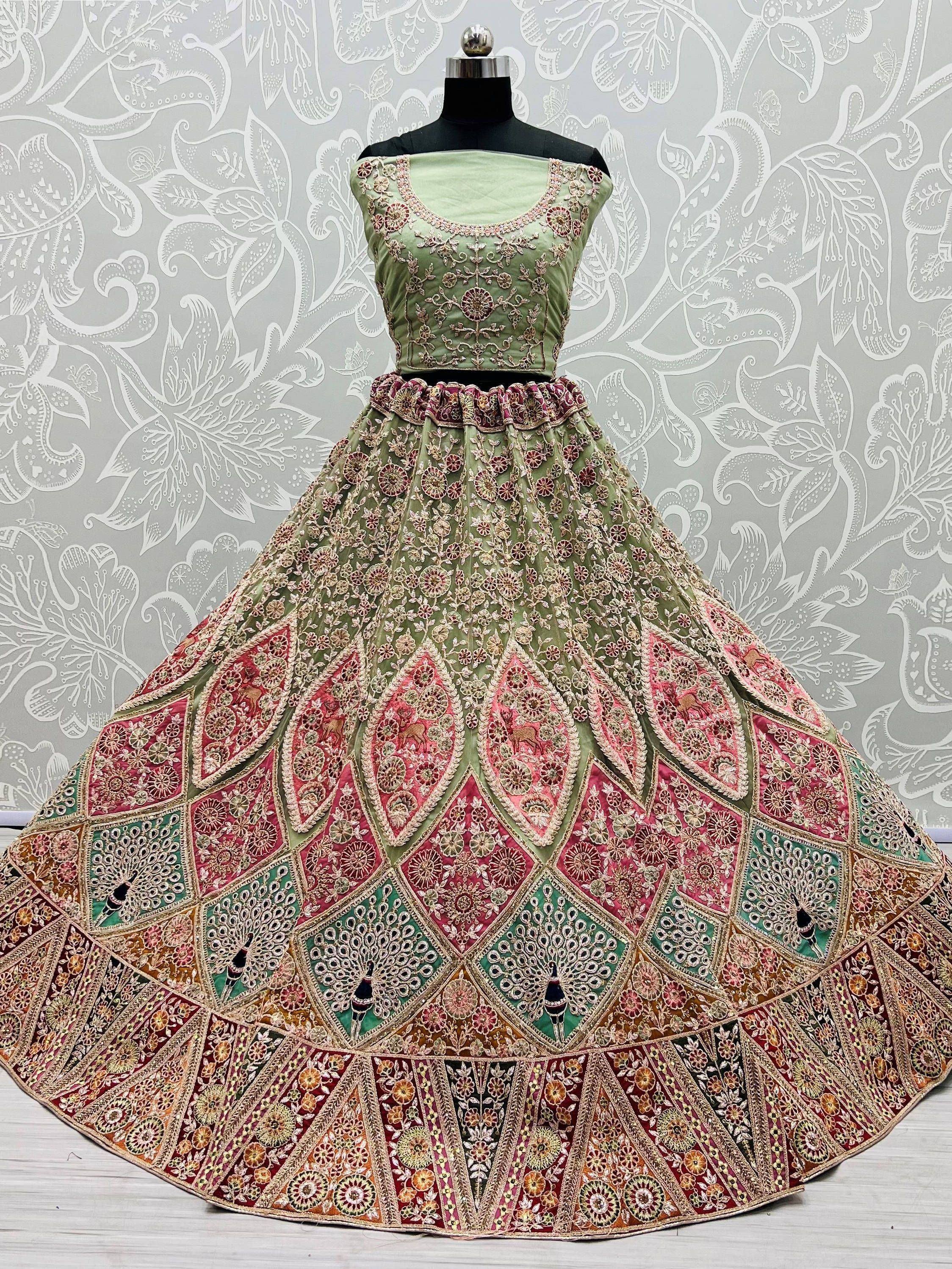 Green and pink embroidered lehenga choli with floral and peacock motifs, displayed on mannequin
