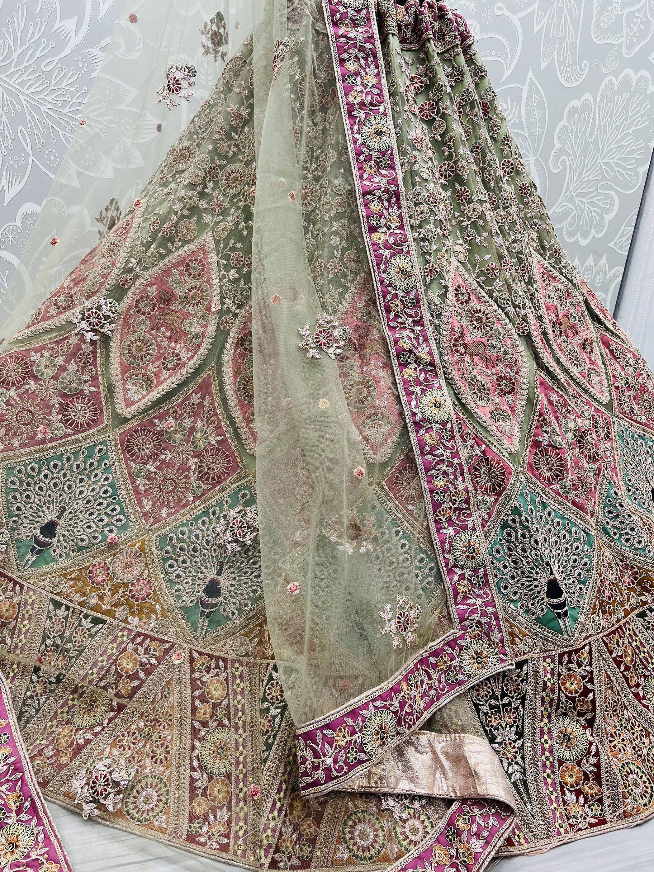 Designer lehenga choli with intricate floral embroidery, peacock motifs, and sheer dupatta for Indian ethnic wear