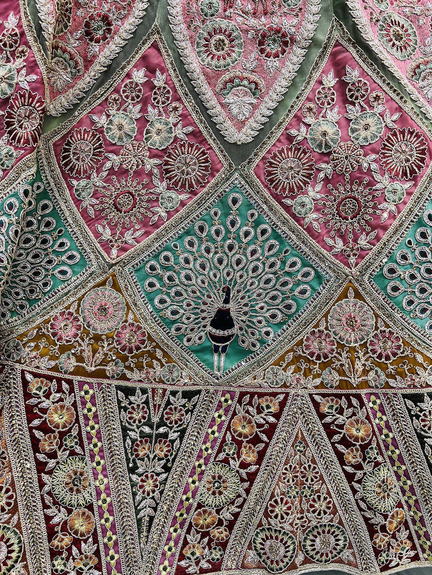 Luxury Indian ethnic wear with intricate peacock and floral embroidery on rich velvet fabric.