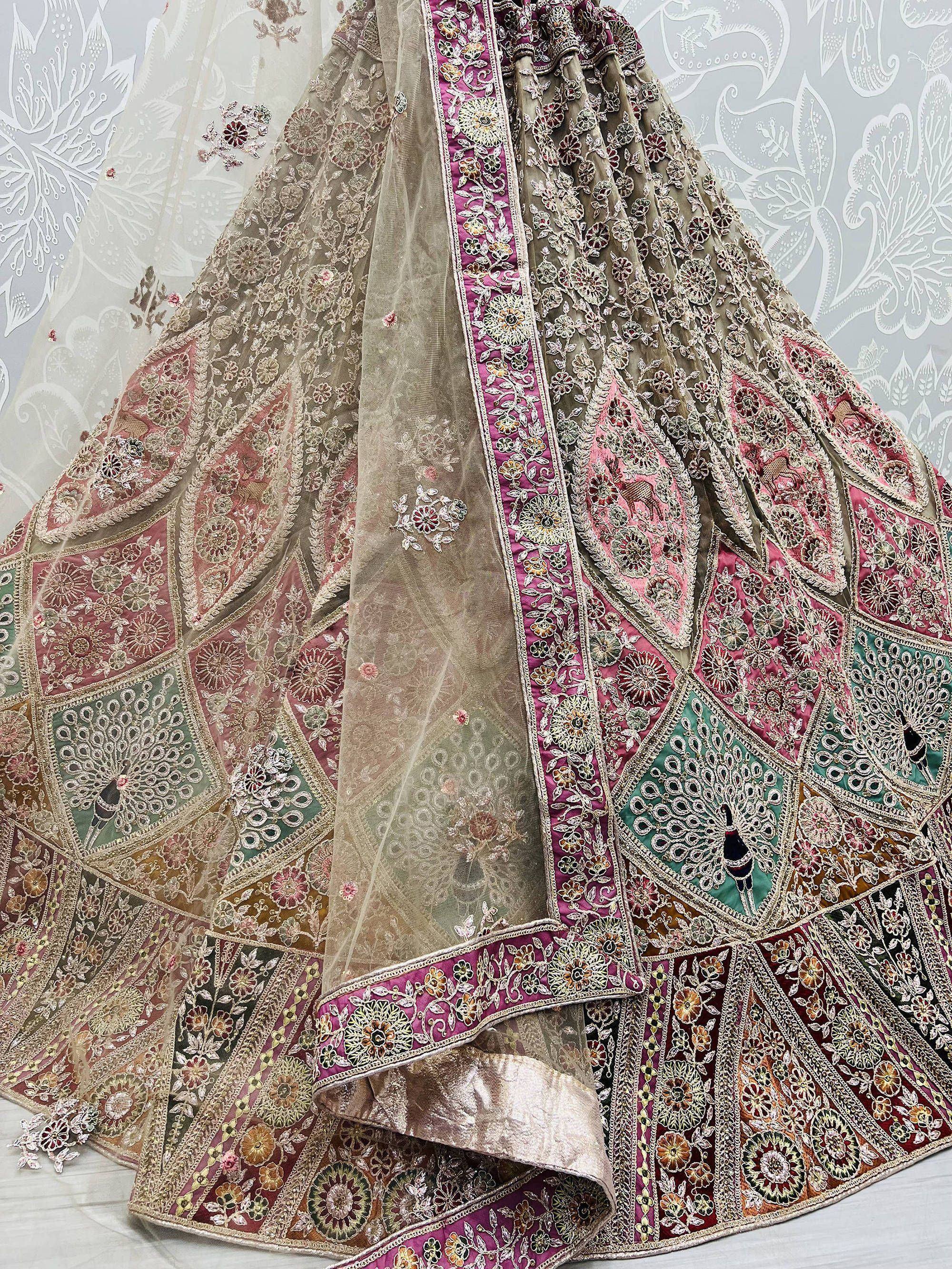 Designer lehenga choli with intricate floral embroidery, peacock motifs, and sheer dupatta for Indian ethnic wear
