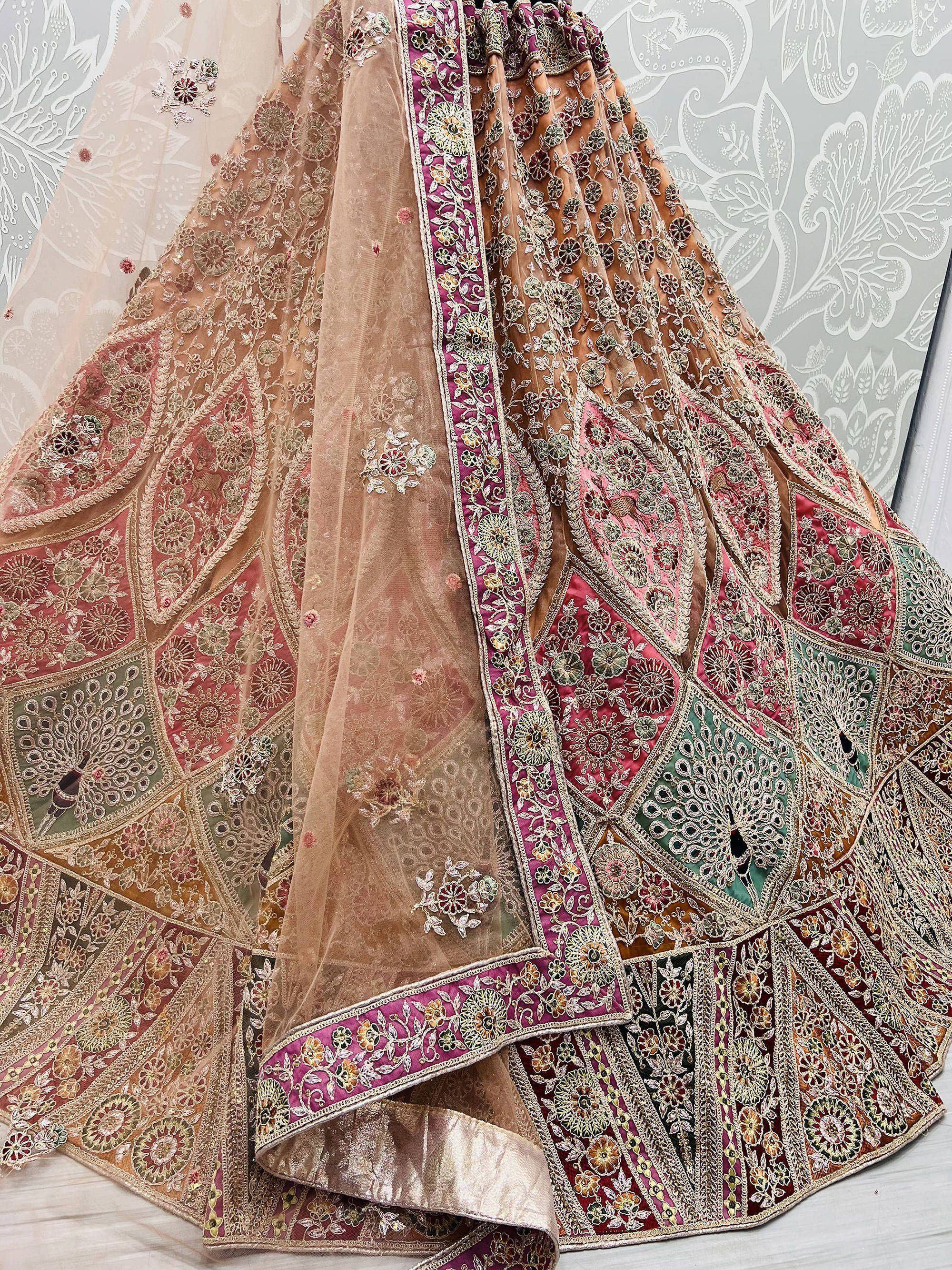 Designer lehenga choli with intricate floral embroidery, patchwork panels, and sheer dupatta for Indian ethnic wear