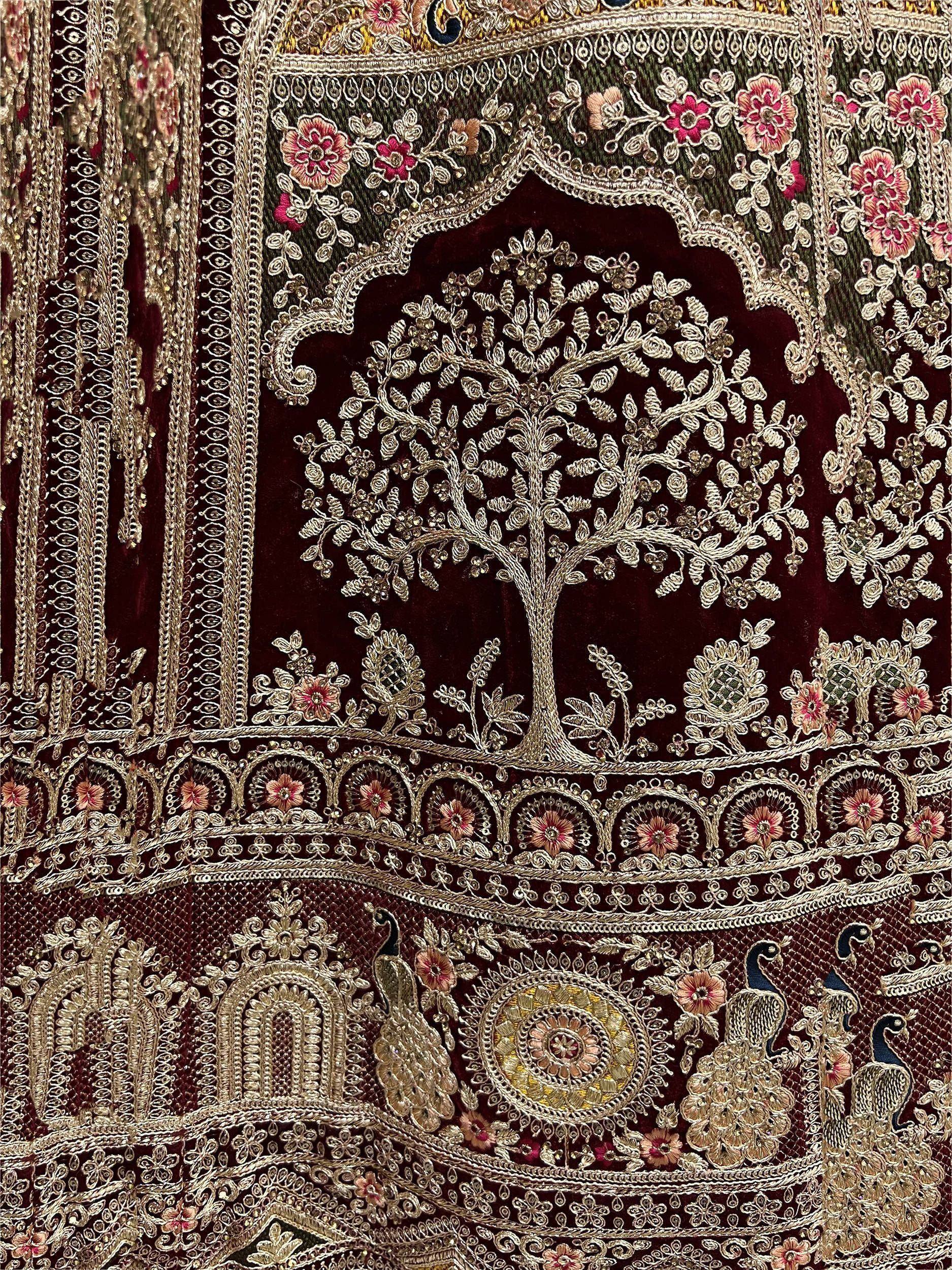 Luxury Indian ethnic wear with intricate gold embroidery, floral patterns, and peacock motifs on velvet fabric