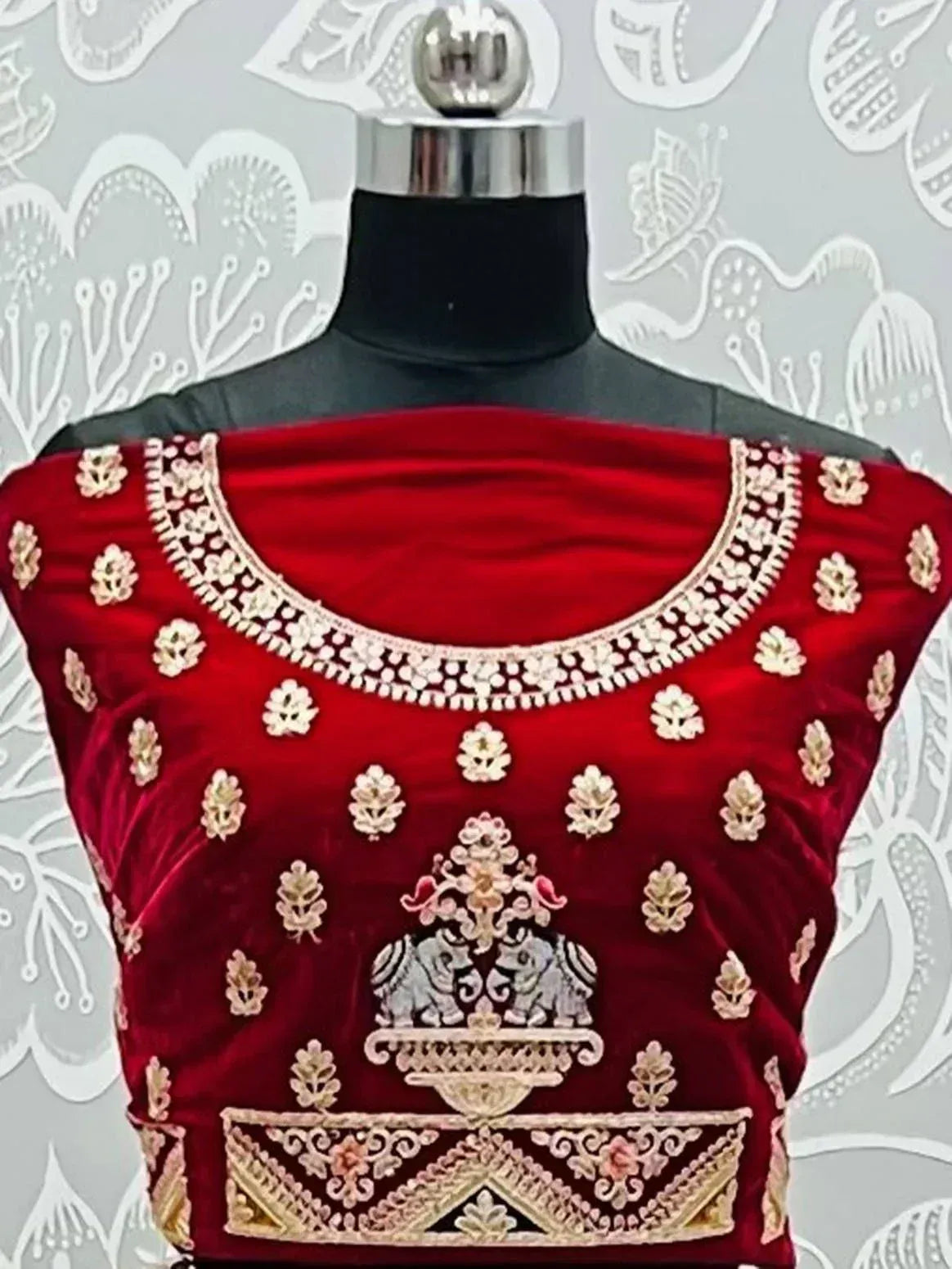 Red velvet designer blouse with gold embroidery, elephant motif, and floral patterns for ethnic wear