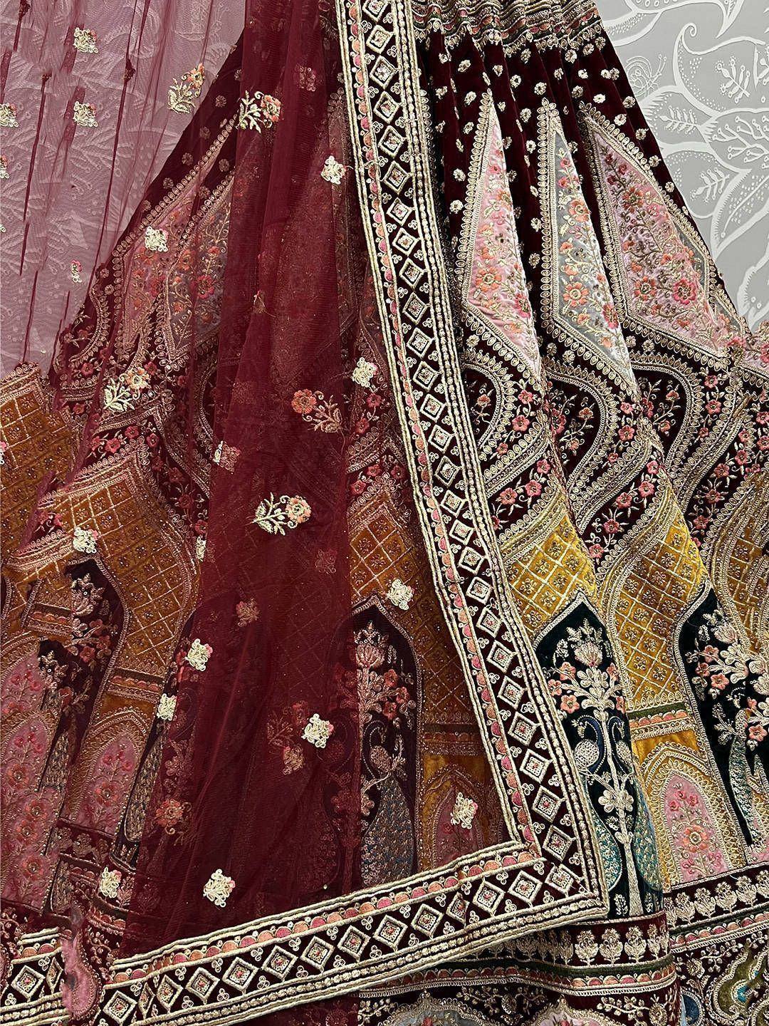 Luxury maroon velvet lehenga with intricate floral embroidery and heavy border detailing