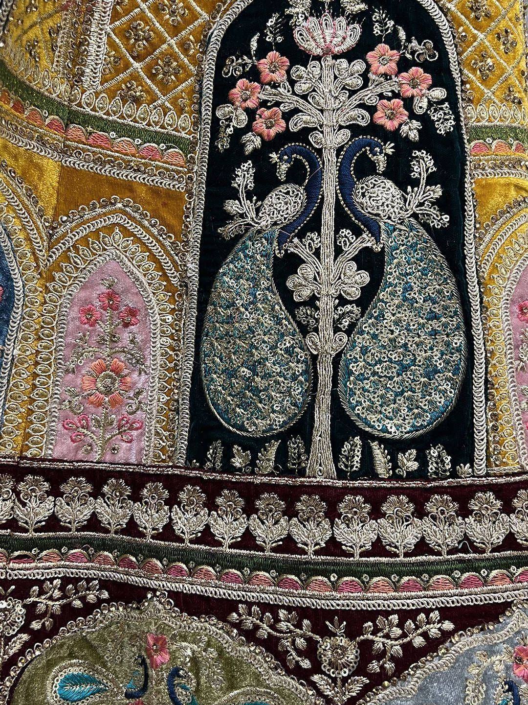 Intricate Indian ethnic embroidery with peacock and floral motifs on velvet, perfect for lehenga or saree designs