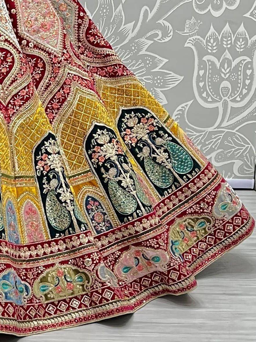 Designer lehenga with peacock embroidery, floral motifs, and rich red-gold border for Indian ethnic wear
