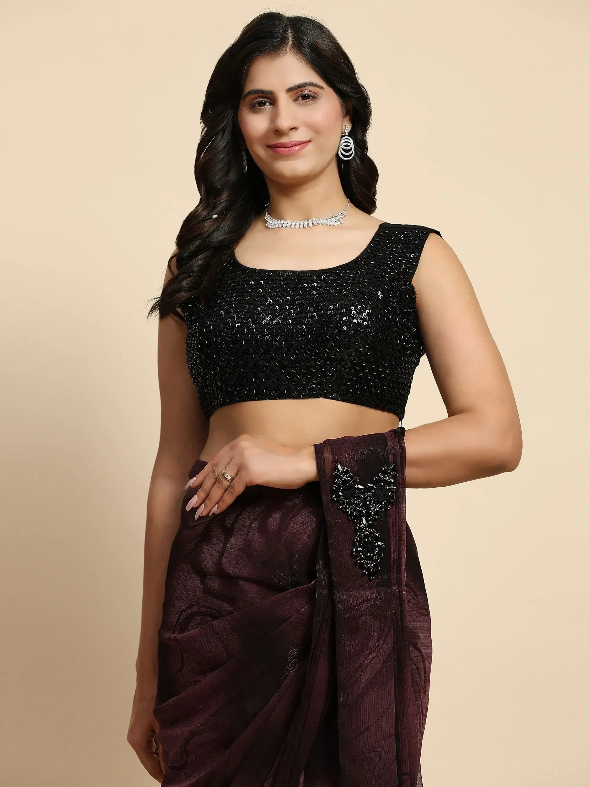 Woman in black sequin blouse with maroon saree, perfect for Indian ethnic wear occasions.
